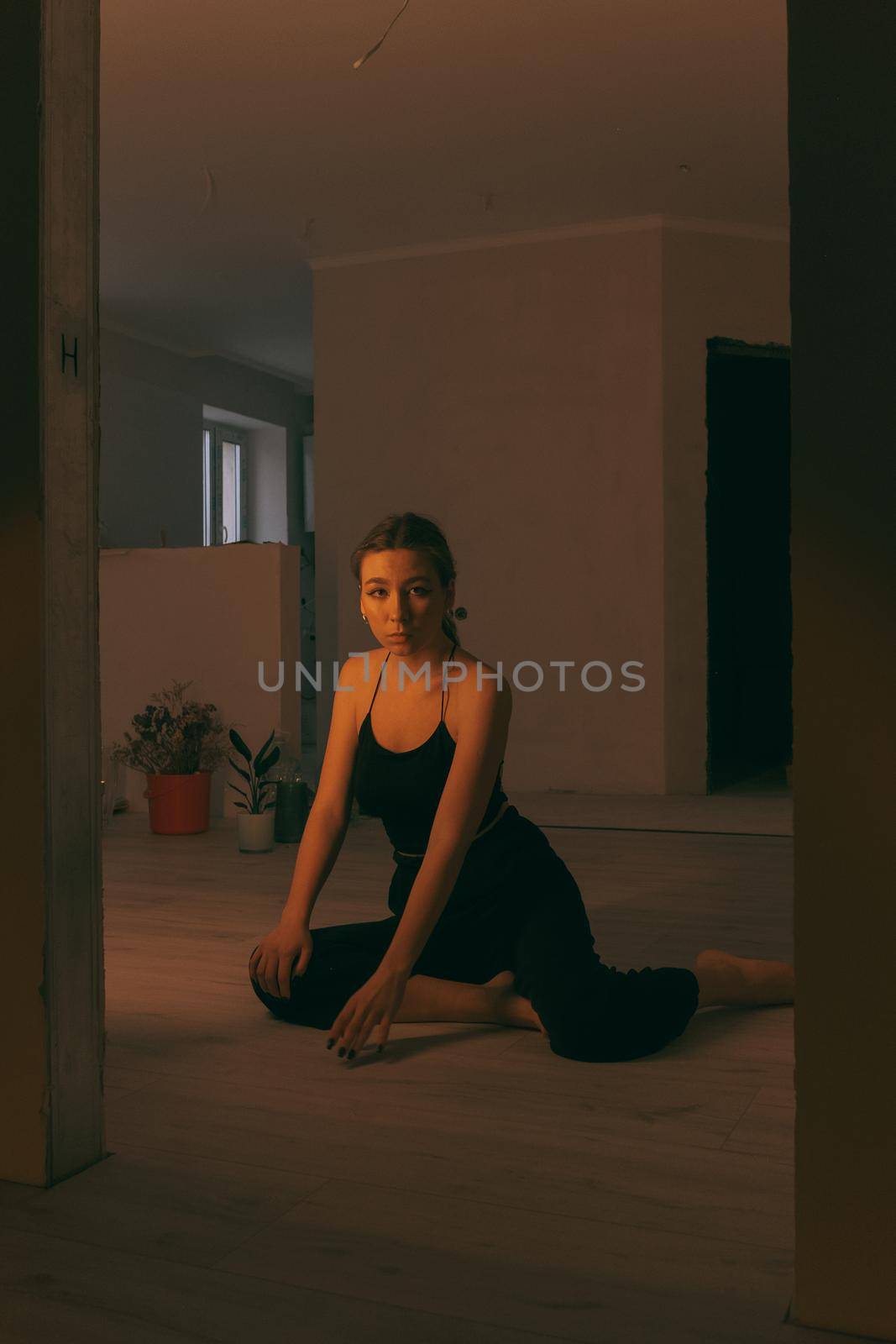 portrait of woman at home during renovation. dark. spot light on the model by Symonenko