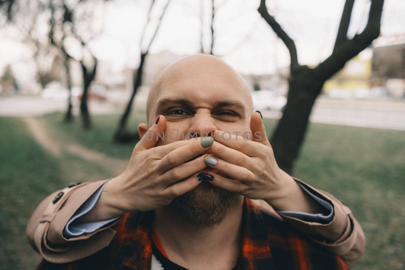 girl closes her lover's eyes from behind. hipster