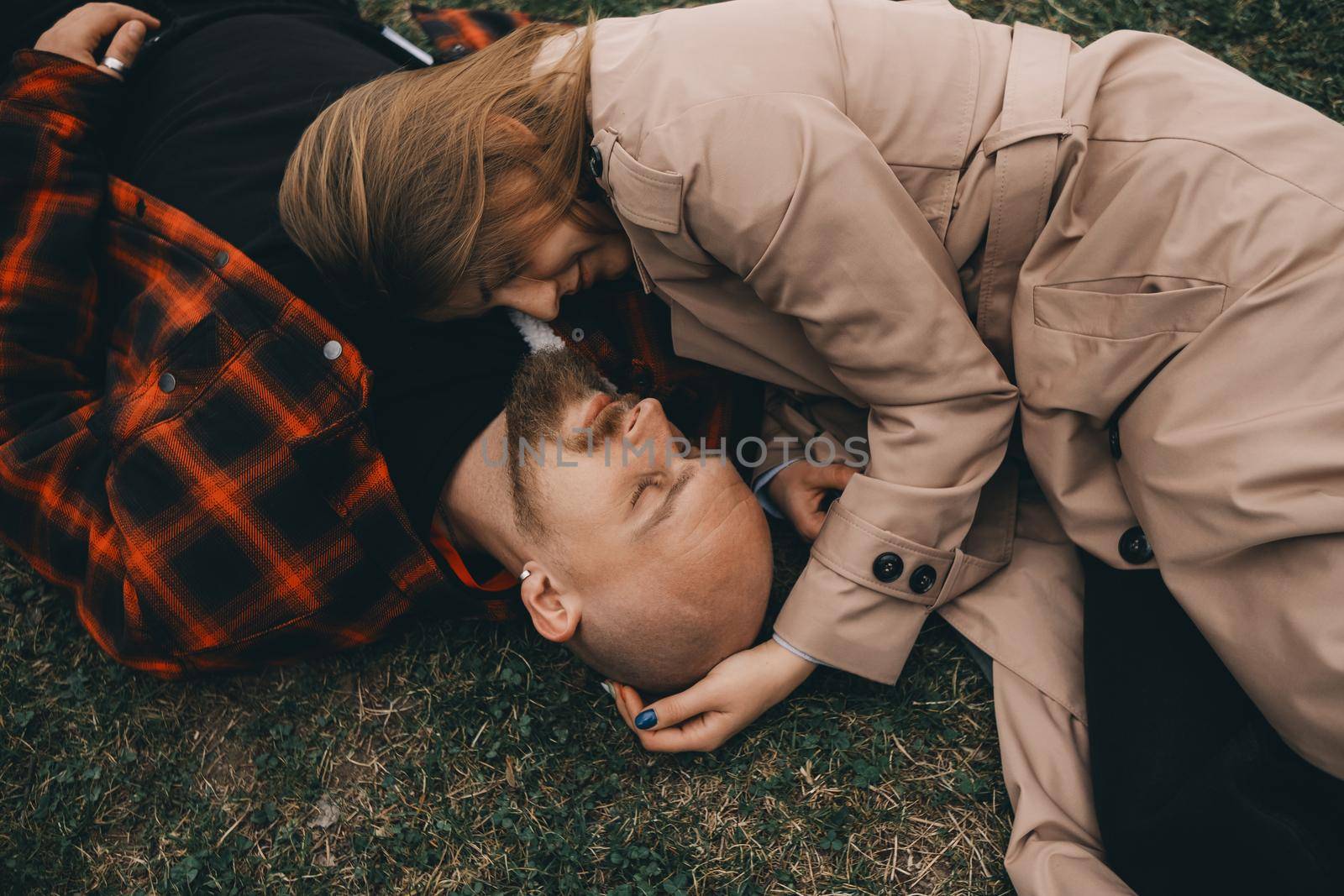 young couple laying on grass. summer love outdoors