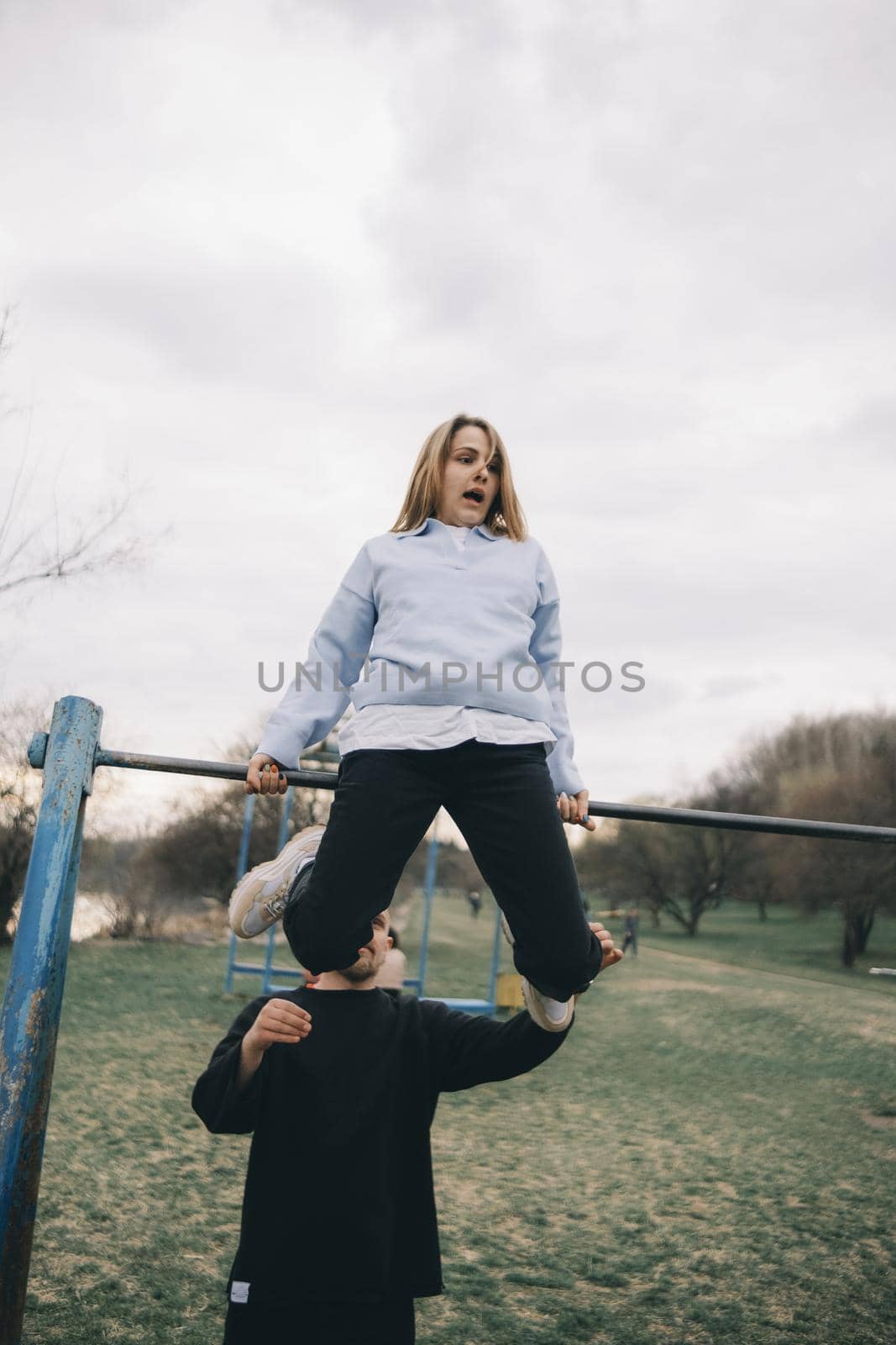 man and woman having fun on the playground by Symonenko