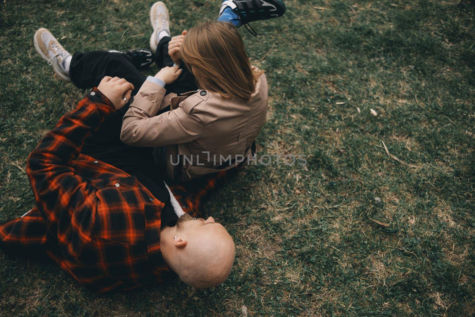 young couple laying on grass. summer love outdoors