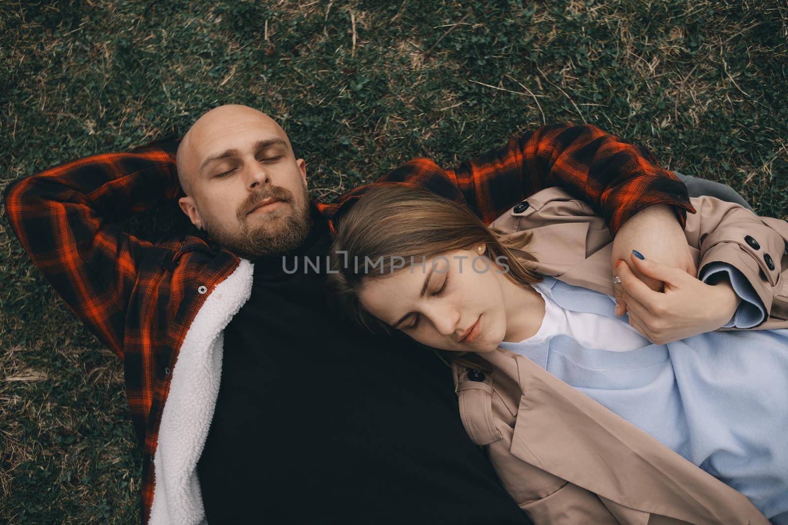 young couple laying on grass. summer love outdoors