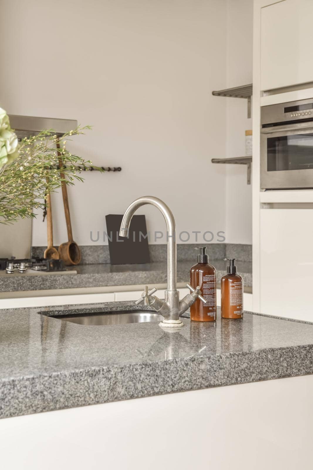 Kitchen faucet close-up with matching accessories in the kitchen of a modern home