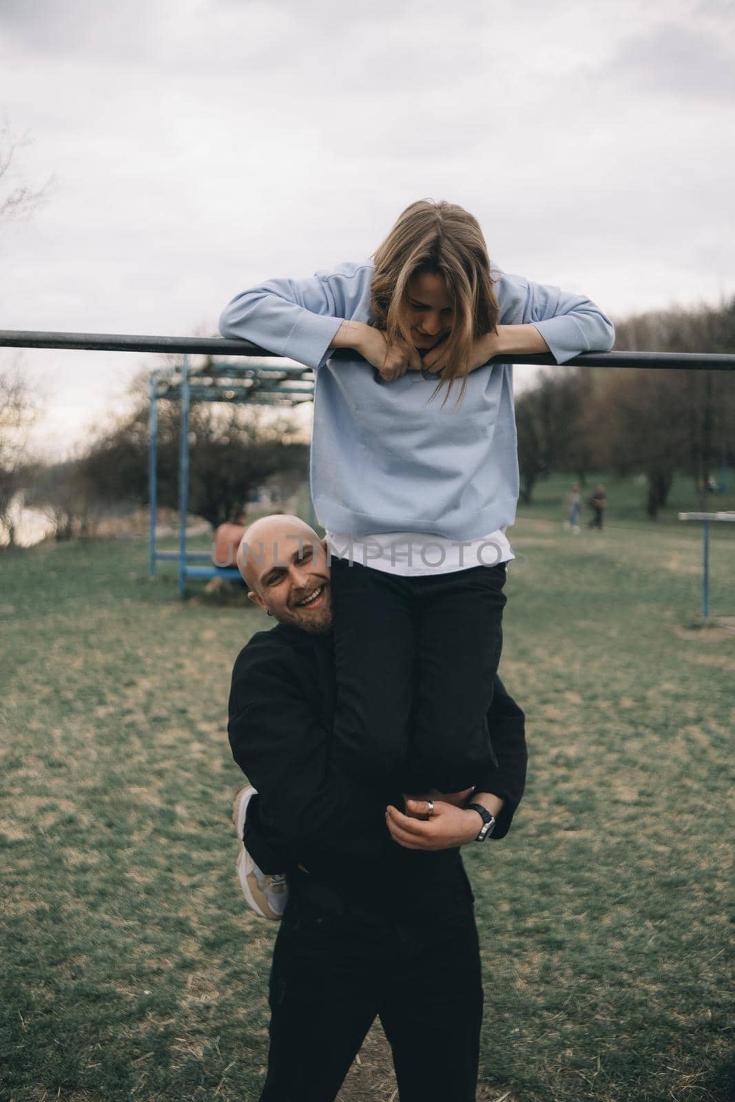 man and woman having fun on the playground by Symonenko