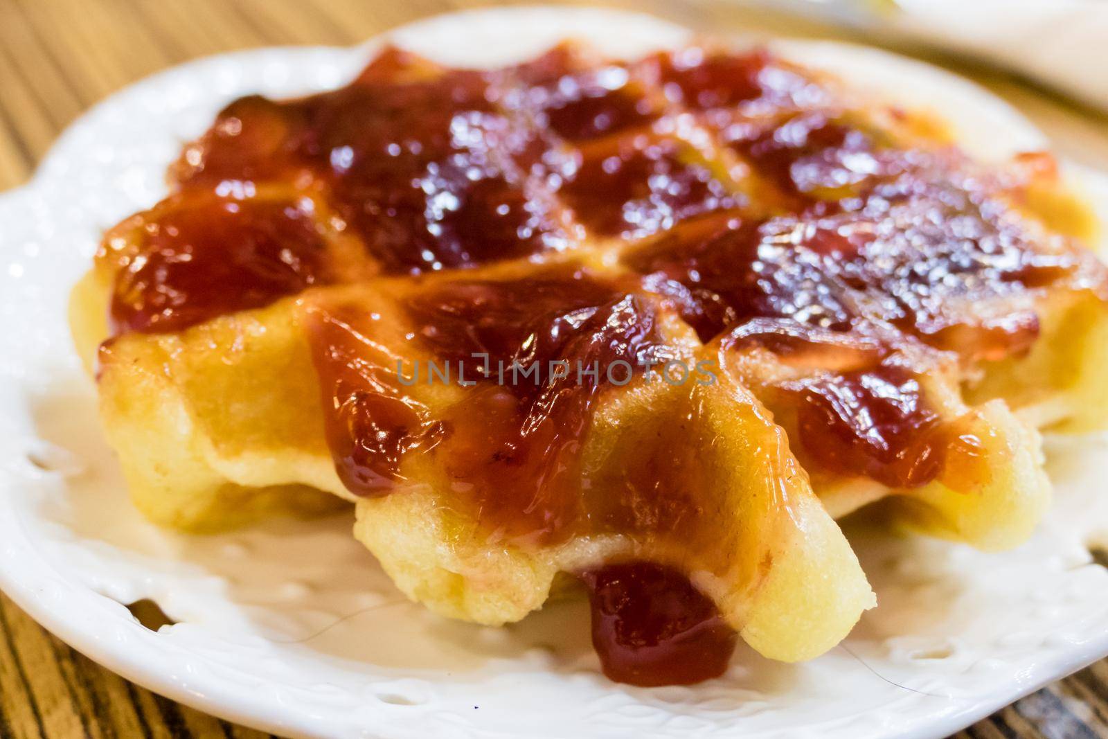 Fresh Belgian liege waffle with strawberry jam by imagesbykenny