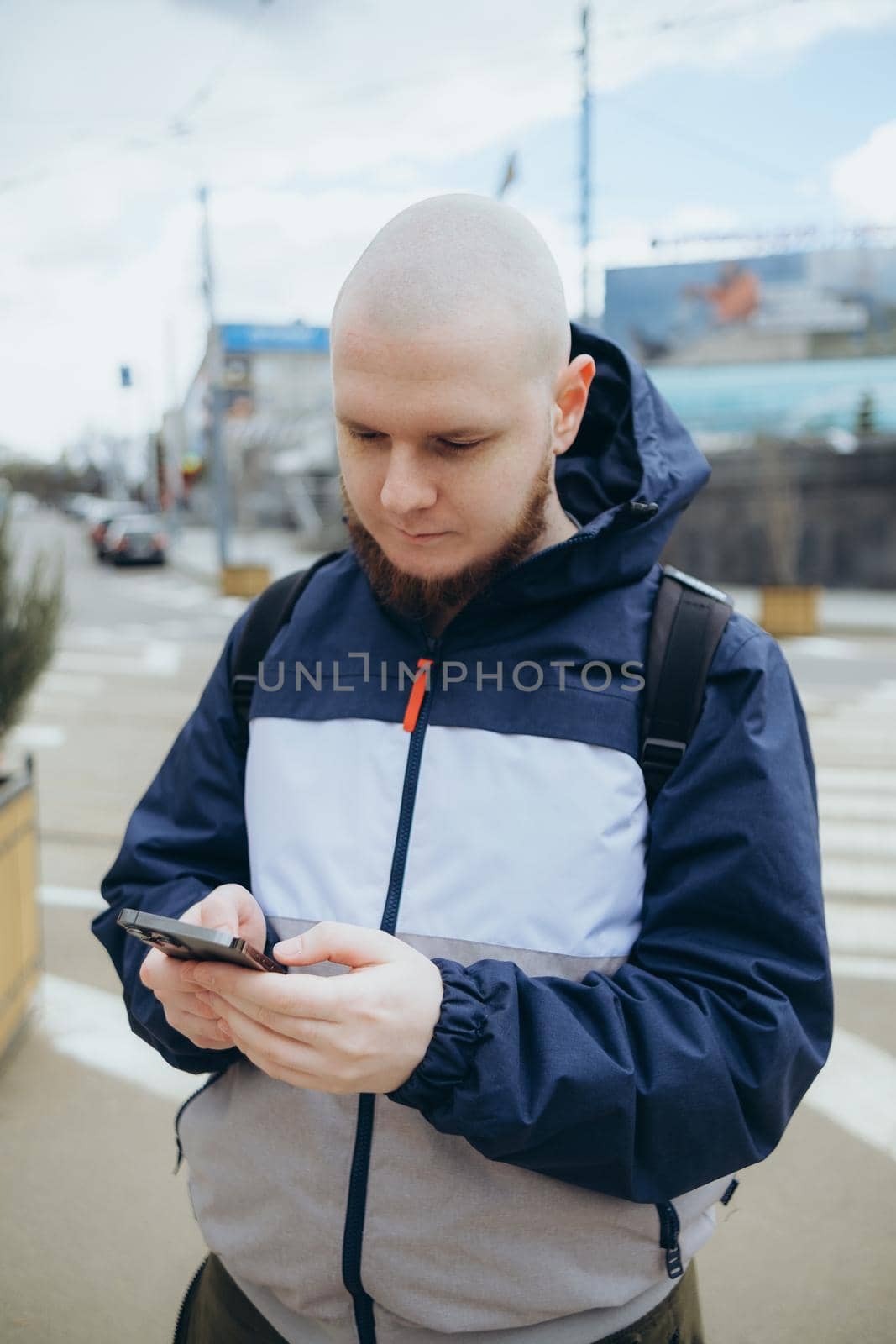 Young irish man smiling happy using smartphone at the city. maps