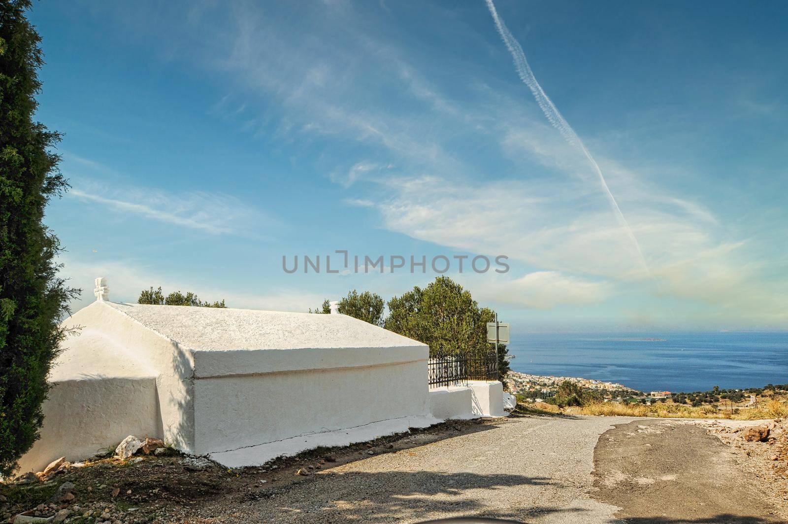 Small white church in Sfentouri village in Aegina by feelmytravel