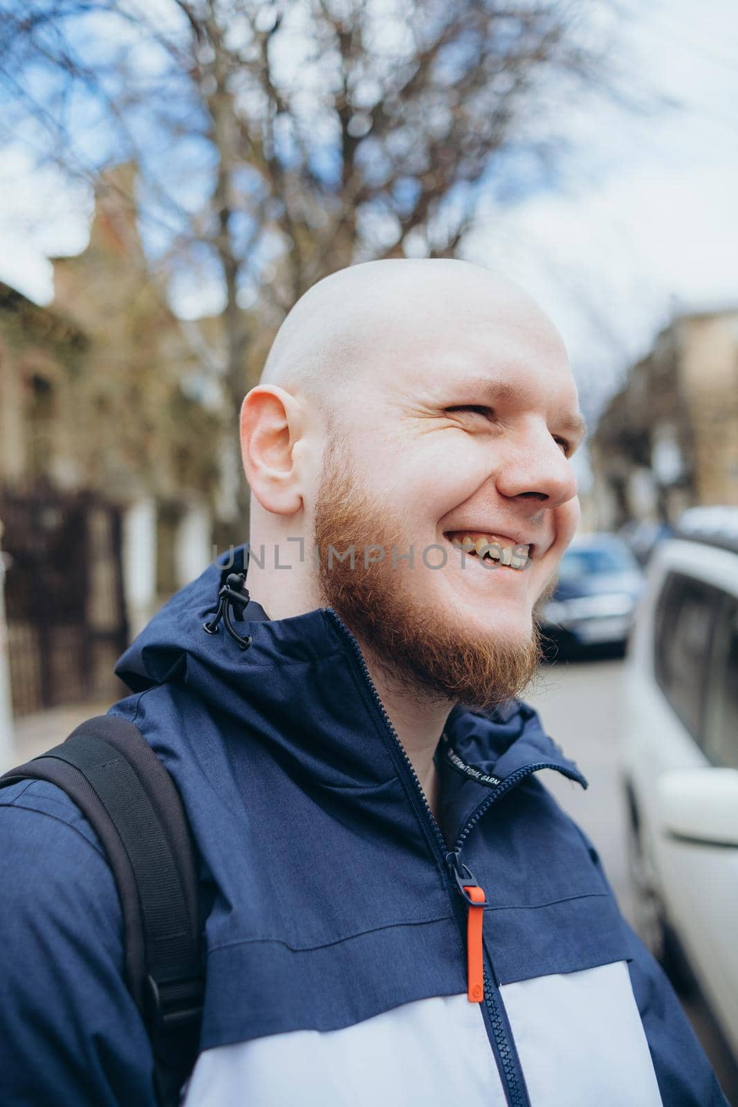 A white man with bald head and beard has a rest in a park by Symonenko