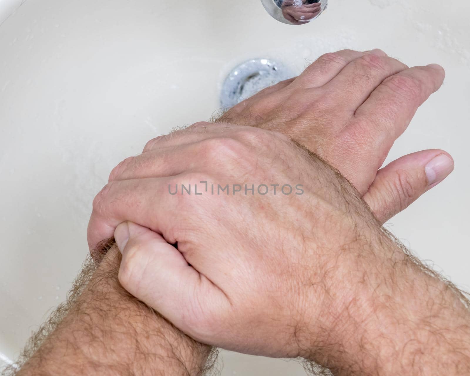 Man washing hands close-up from above by imagesbykenny