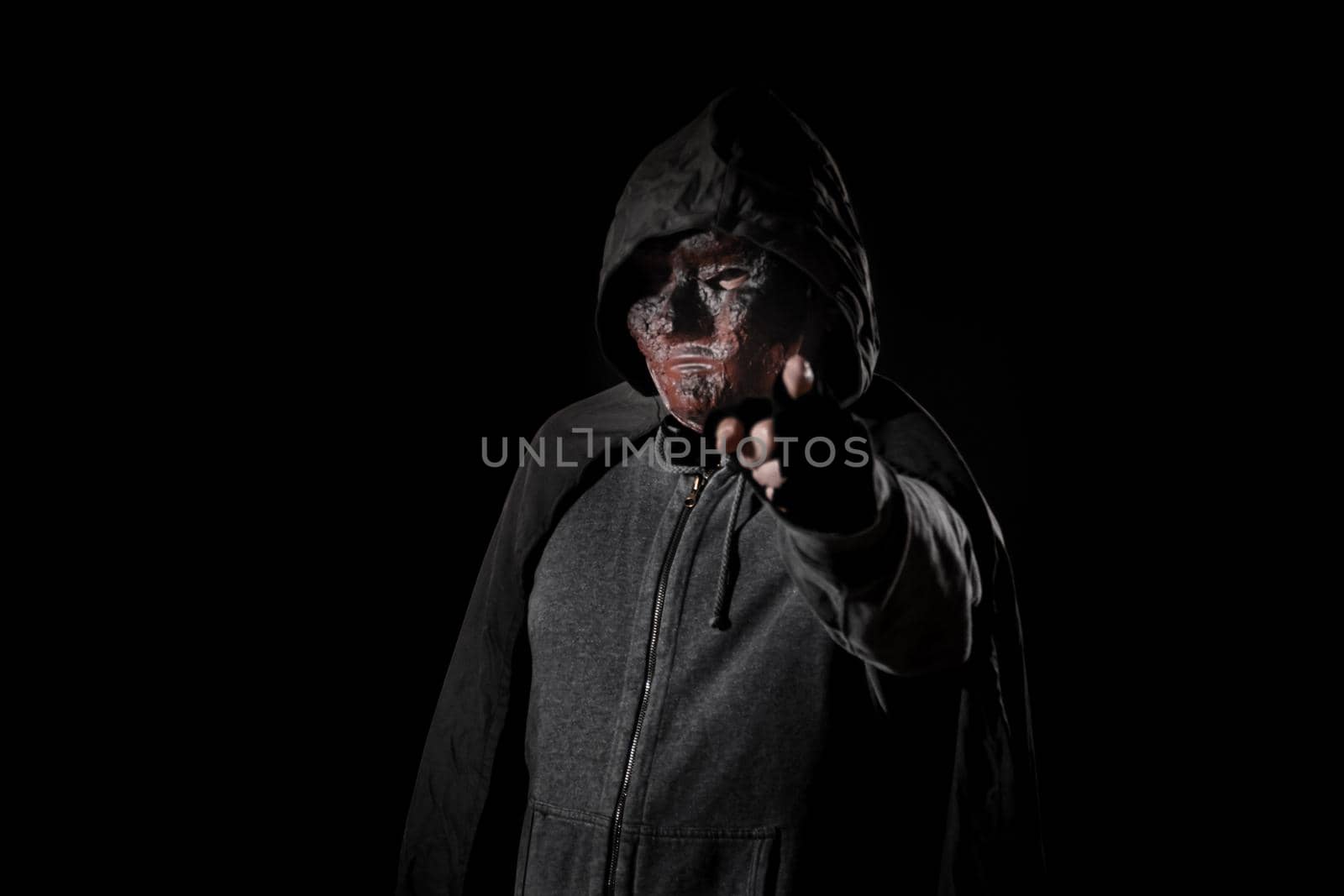 Scary killer in mask holding knife by imagesbykenny