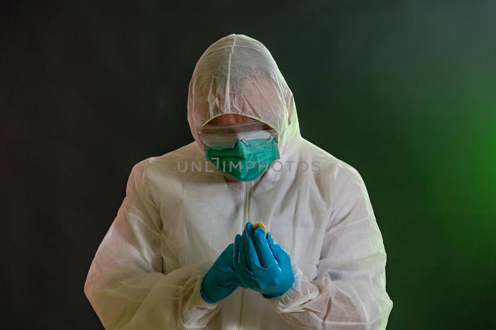 Man in chemical suit inspecting possible toxic materials by imagesbykenny