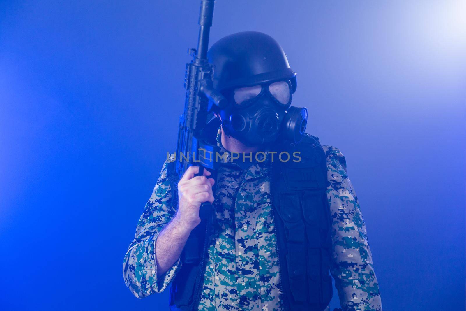Soldier holding assault rifle in smoky haze by imagesbykenny