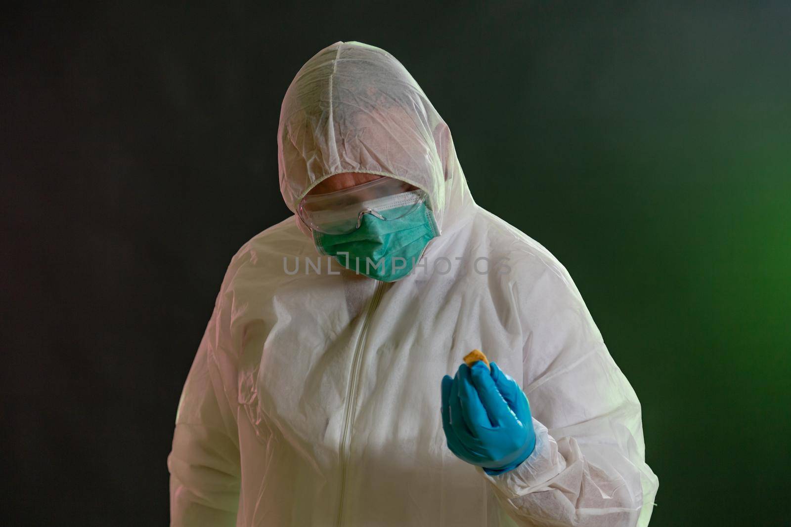 Man in chemical suit inspecting possible toxic materials