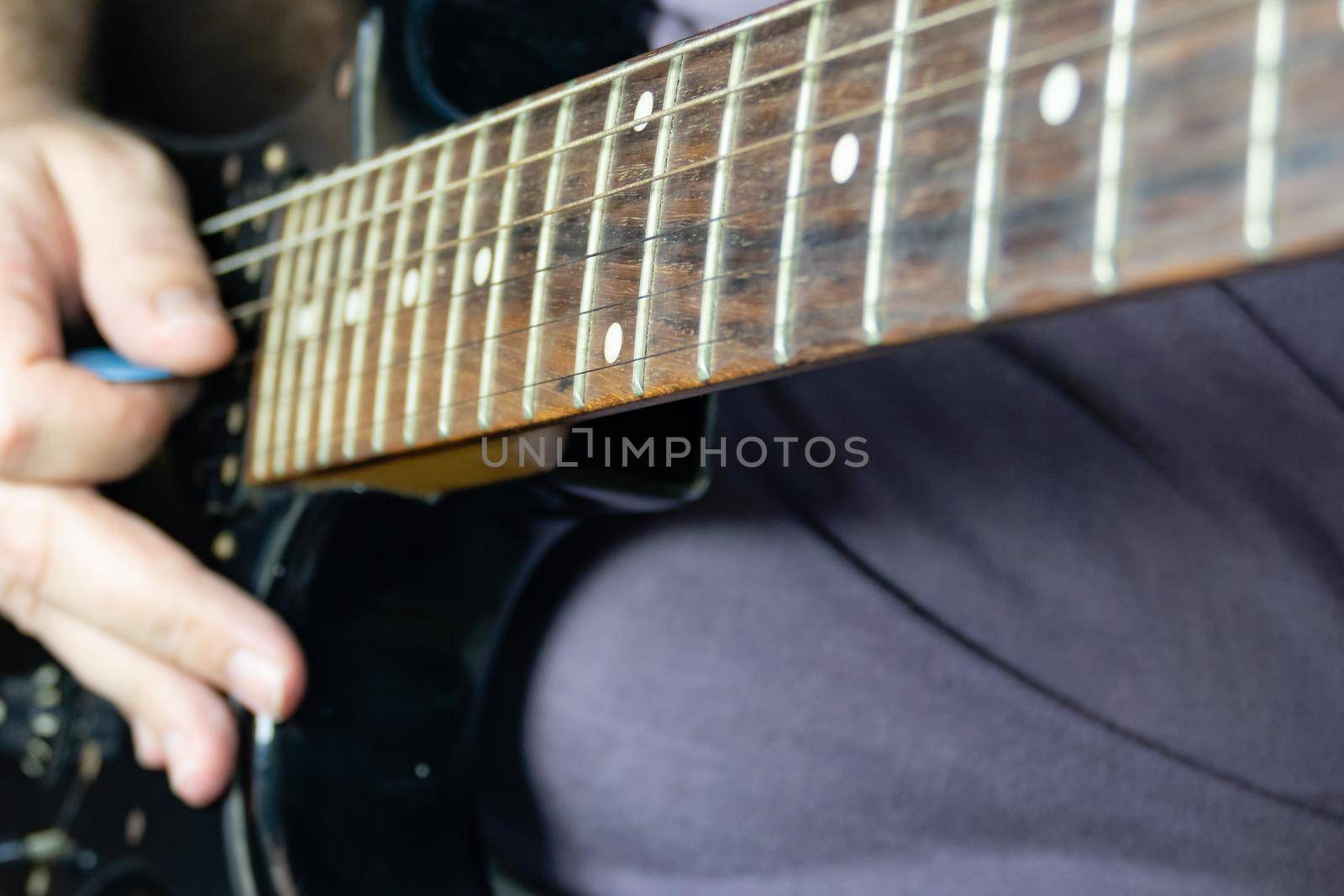 Close-up of man playing lead guitar solo  by imagesbykenny
