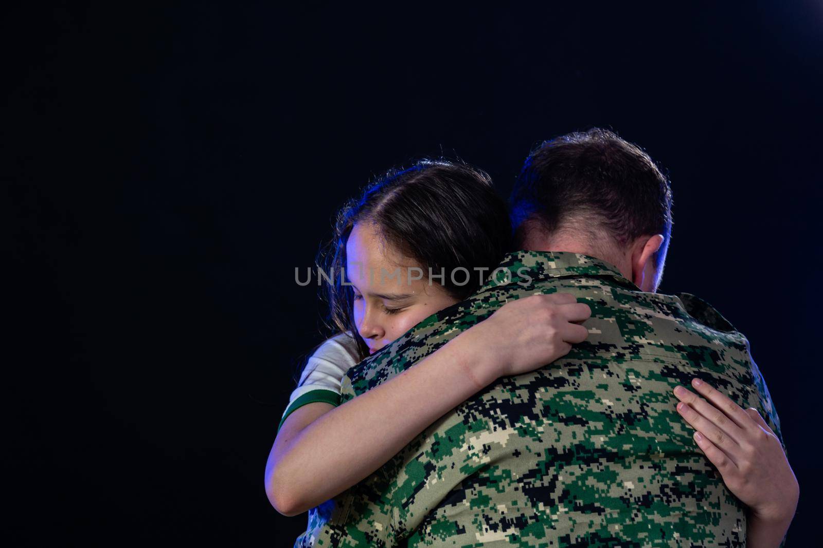 Soldier hugs daughter on departing or returning from war