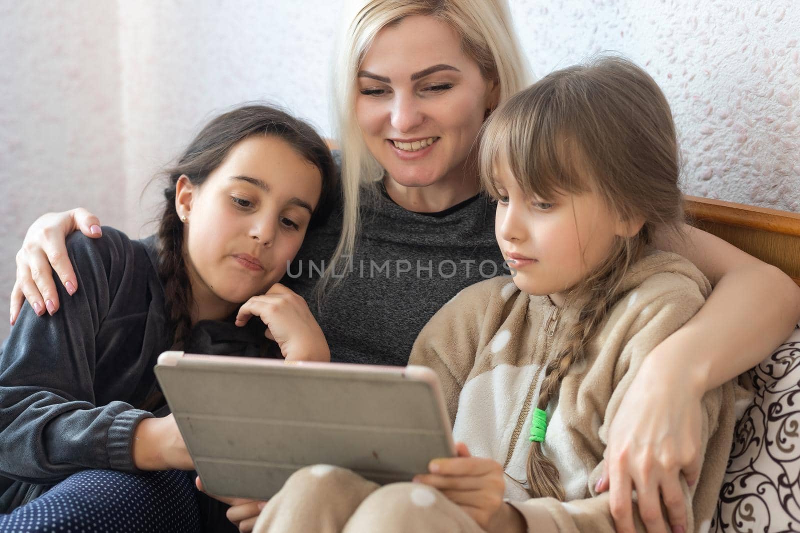 Mother with two children using Tablet PC.