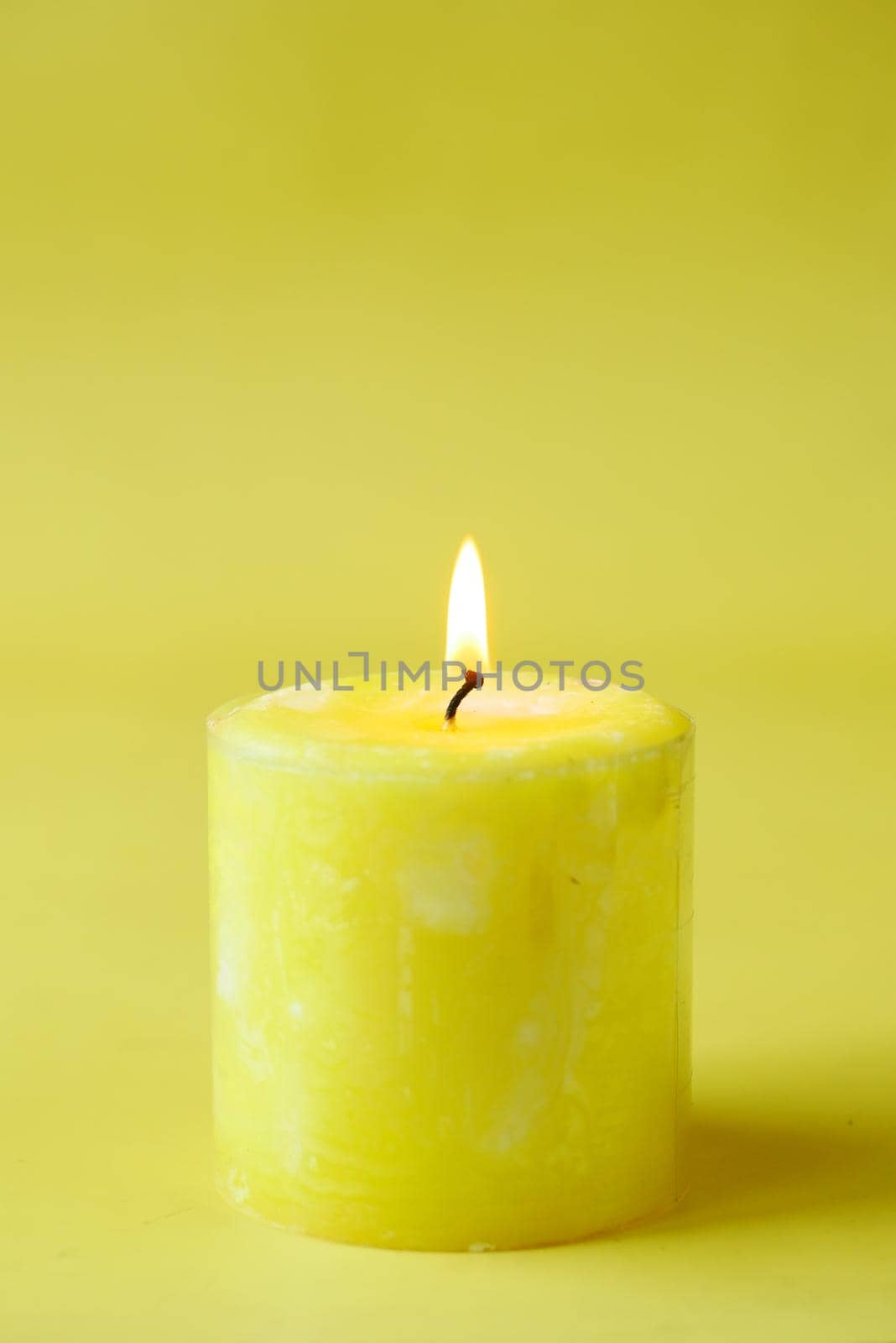 yellow color candles slowly burning down