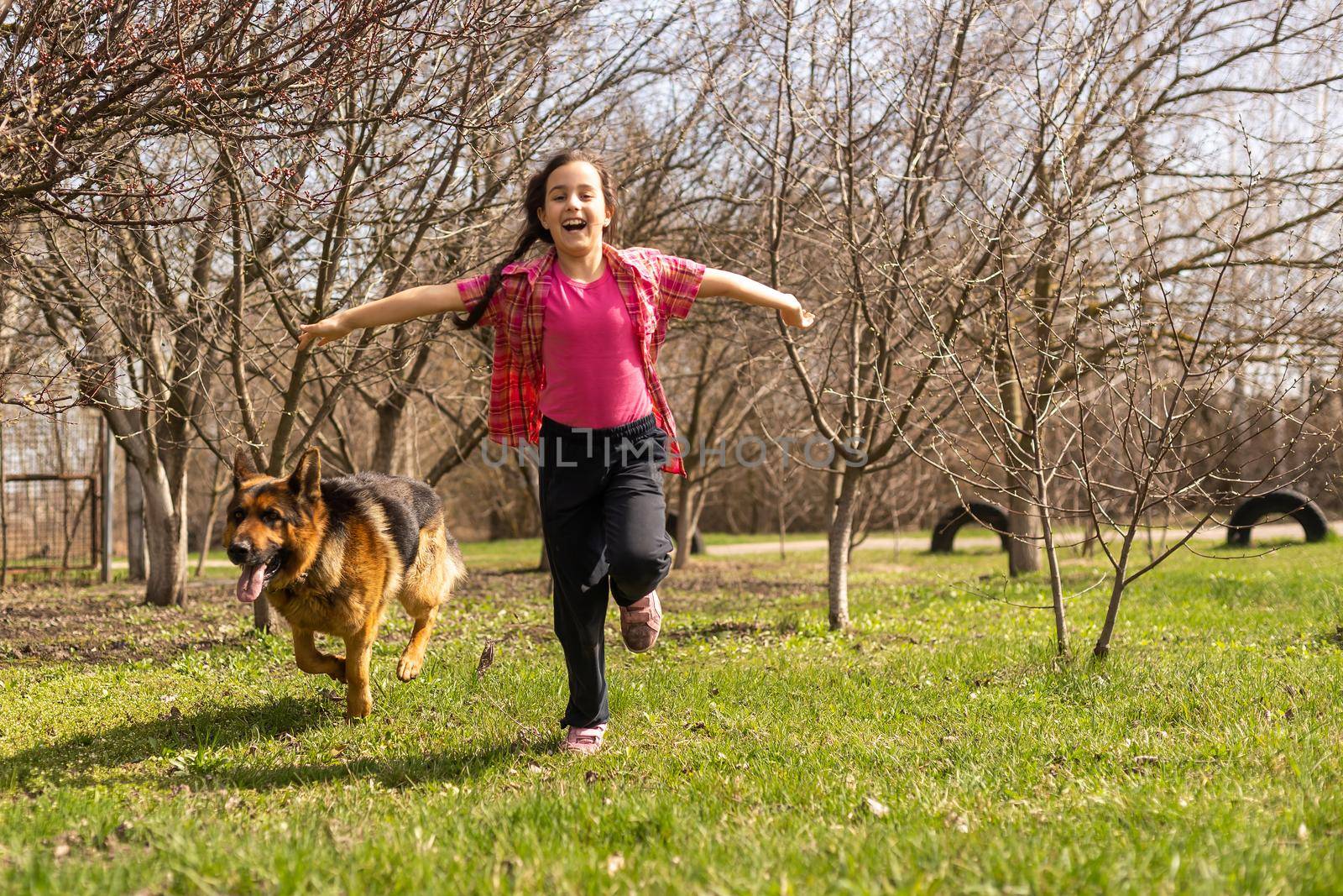 little girl running with his pet german shepherd by Andelov13