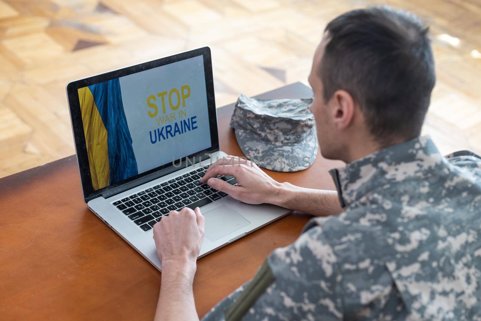 Stand with Ukraine on Social Media concept background with Laptop. military with the flag of Ukraine by Andelov13