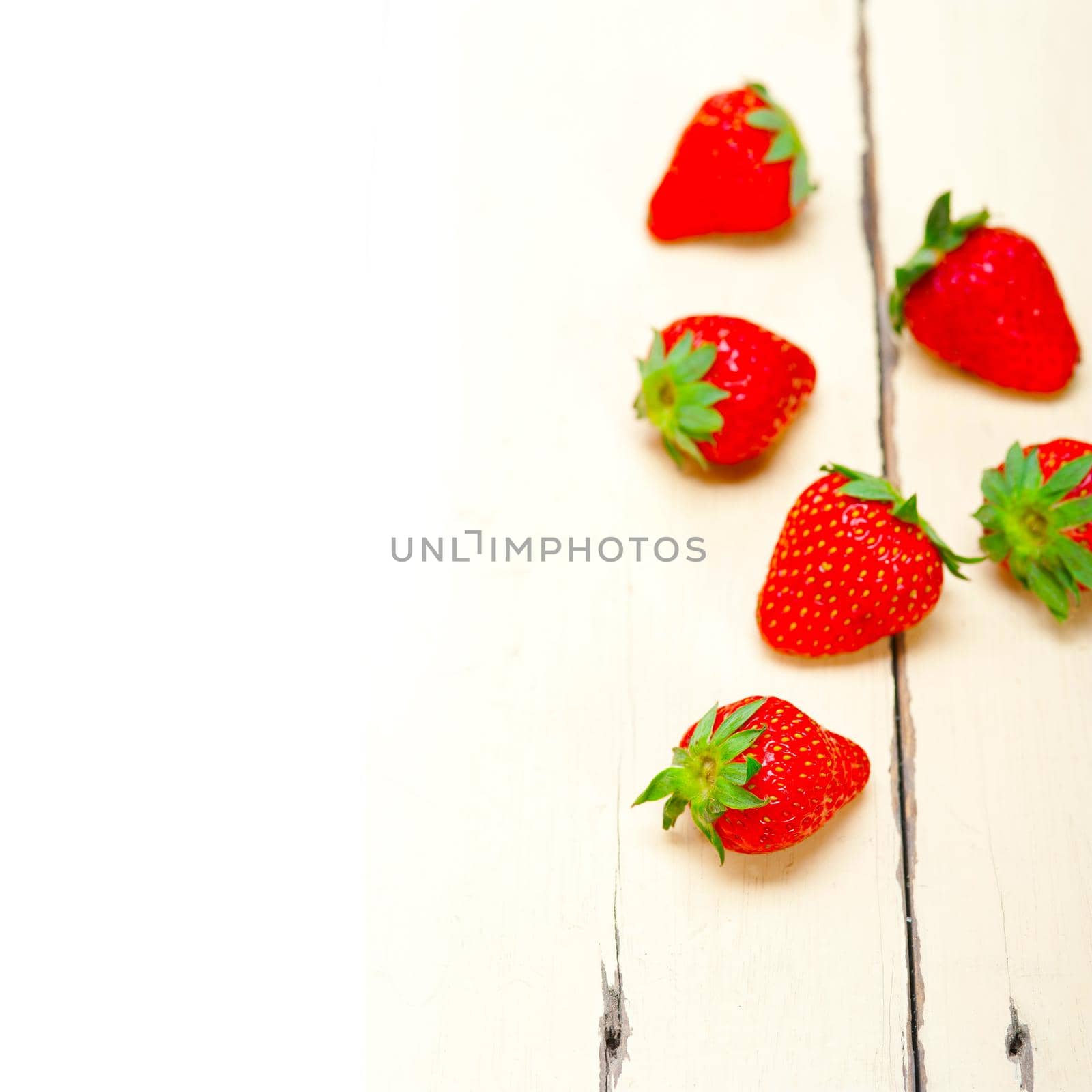 fresh organic strawberry over white wood by keko64