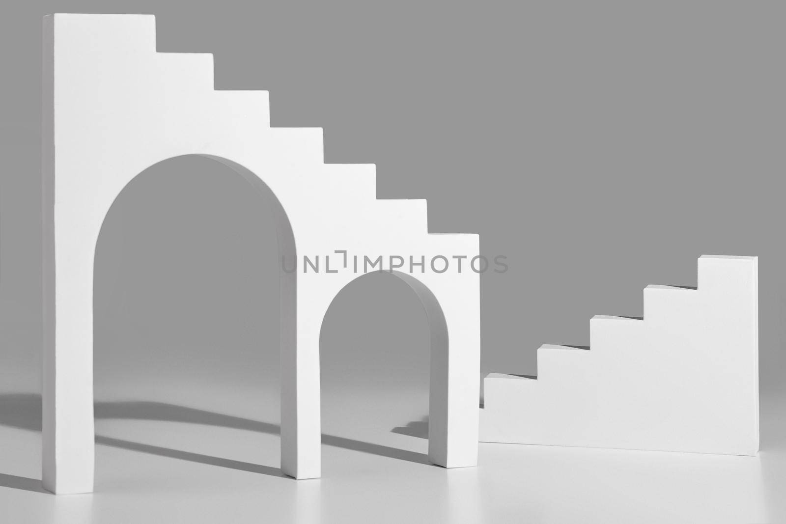 Simple geometrical shapes with arches and steps on gray background by nazarovsergey