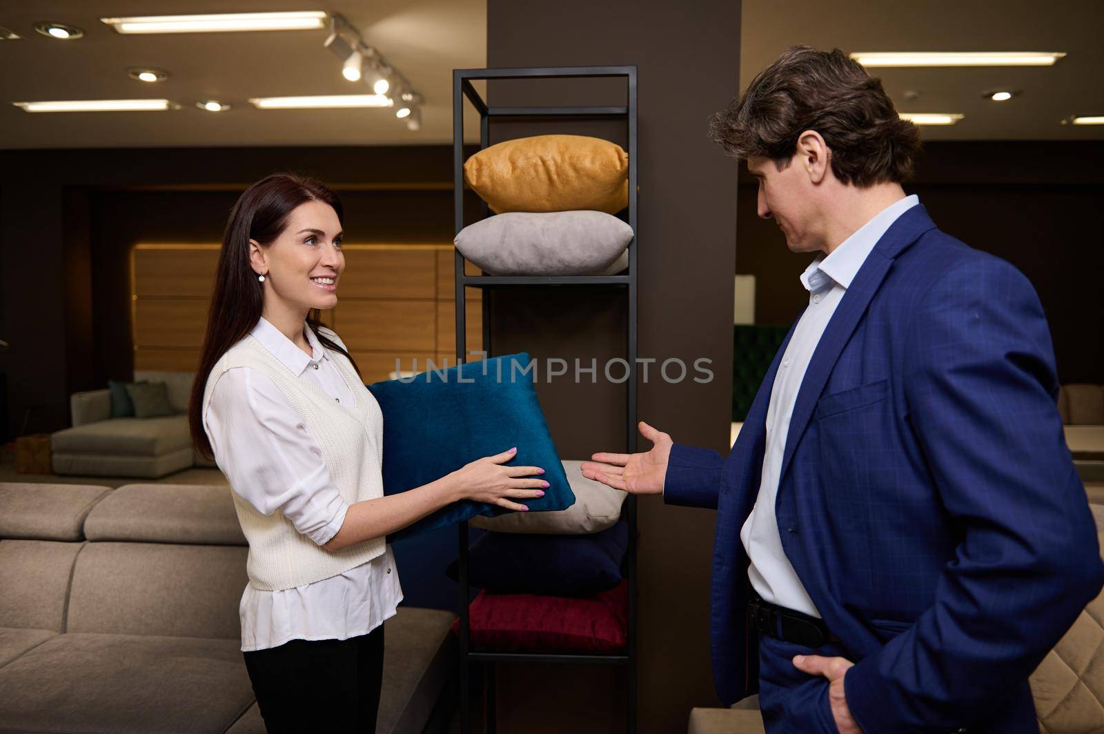 Married couple choosing pillow at store of household goods. Furniture store exhibition center. Home interior decor and improvement, interior design. by artgf