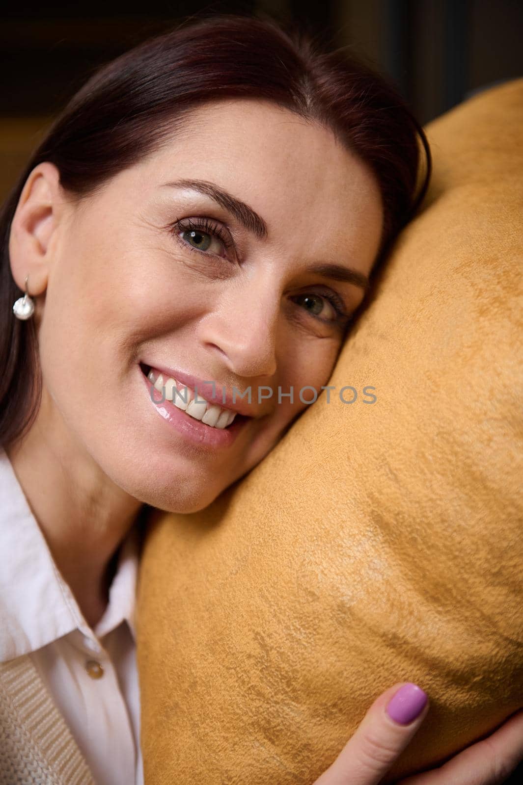 Beautiful woman shopping for pillows and cushions in furniture store by artgf