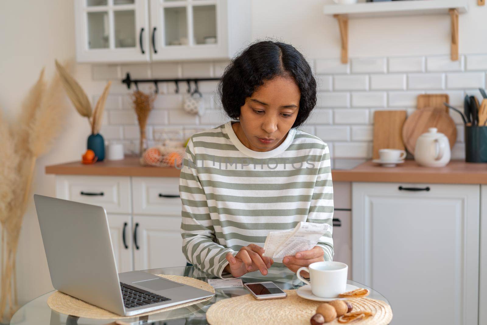 African-american woman paying bills on smartphone. Concept of calculating expenses and planning budget. Communal and mortgage payments. Financial checking. Saving money. Paying off debt