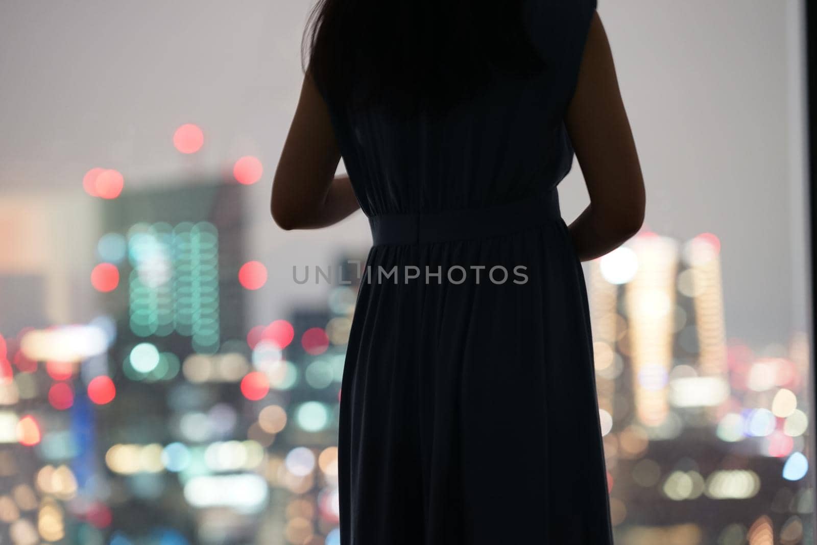 Silhouette of a night view and a woman. Shooting Location: Tokyo metropolitan area