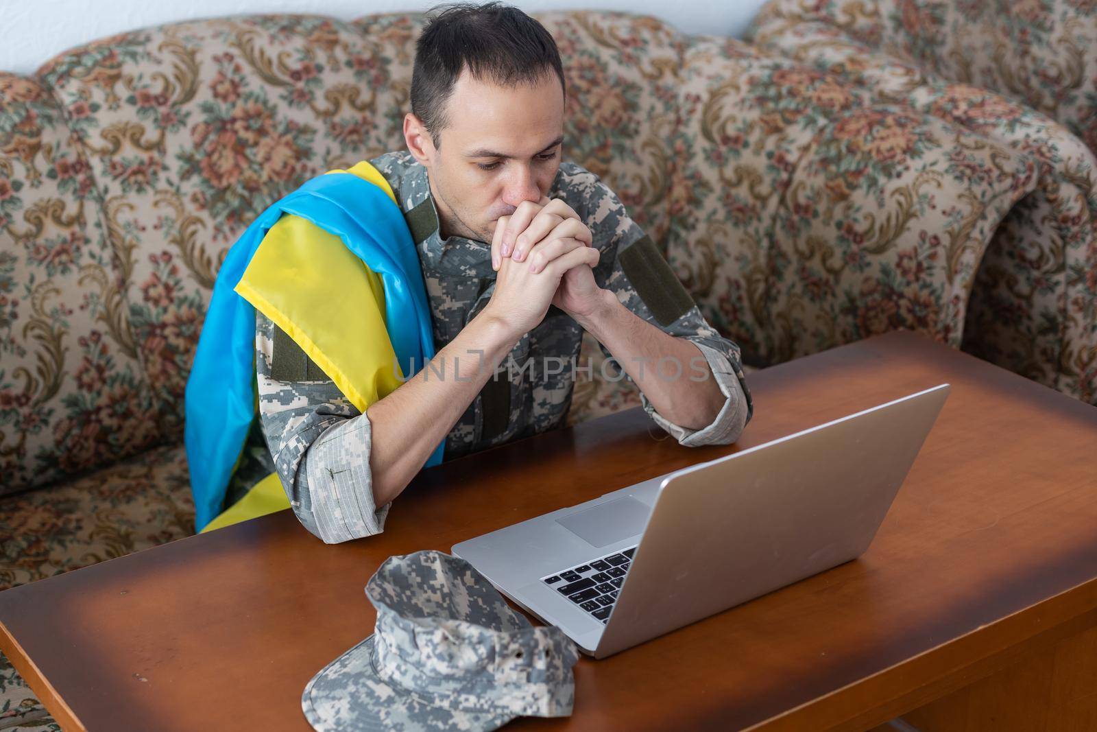 Stand with Ukraine on Social Media concept background with Laptop. military with the flag of Ukraine by Andelov13