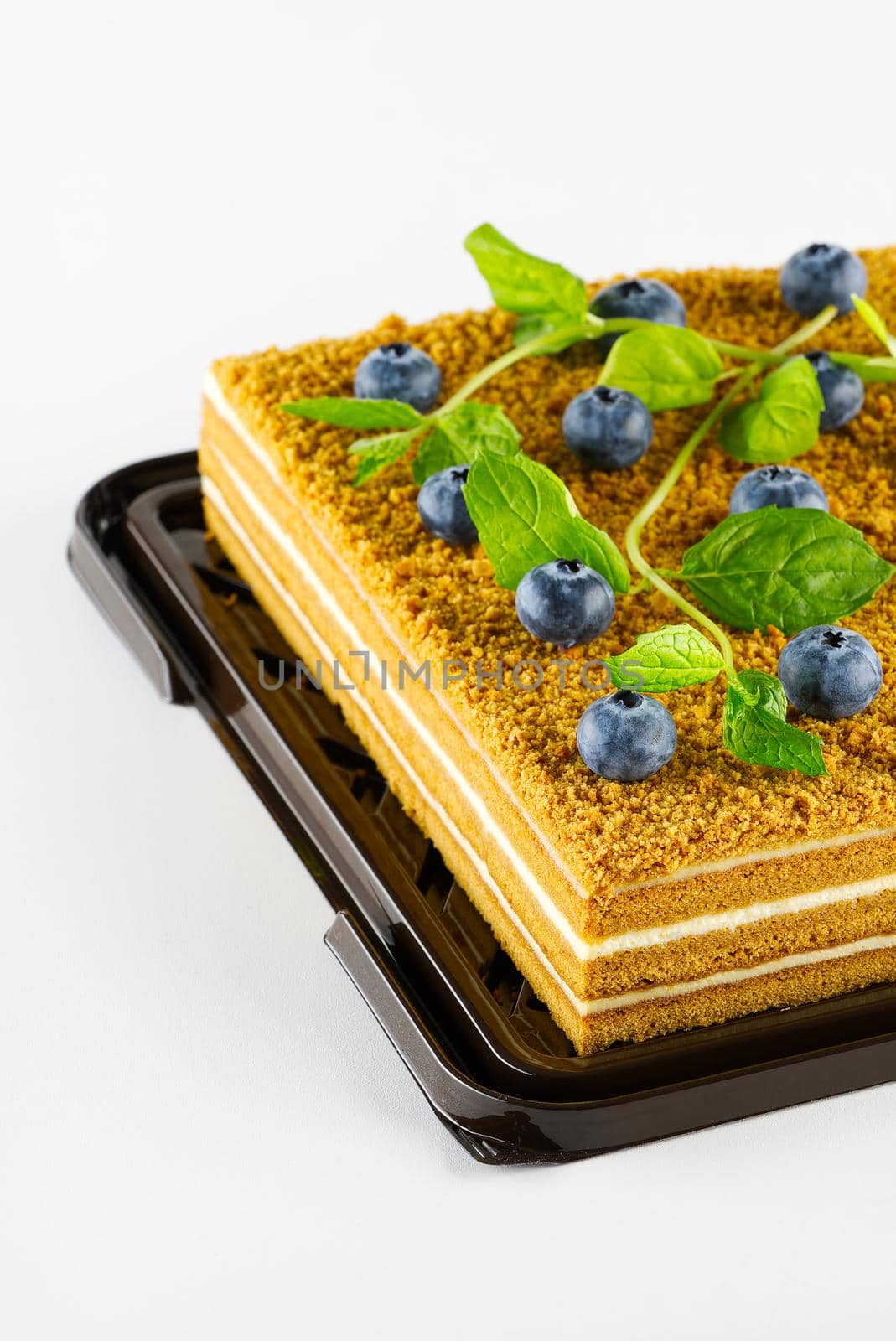 Honey cake with berries close up. Honey cake with blueberries and mint. by PhotoTime