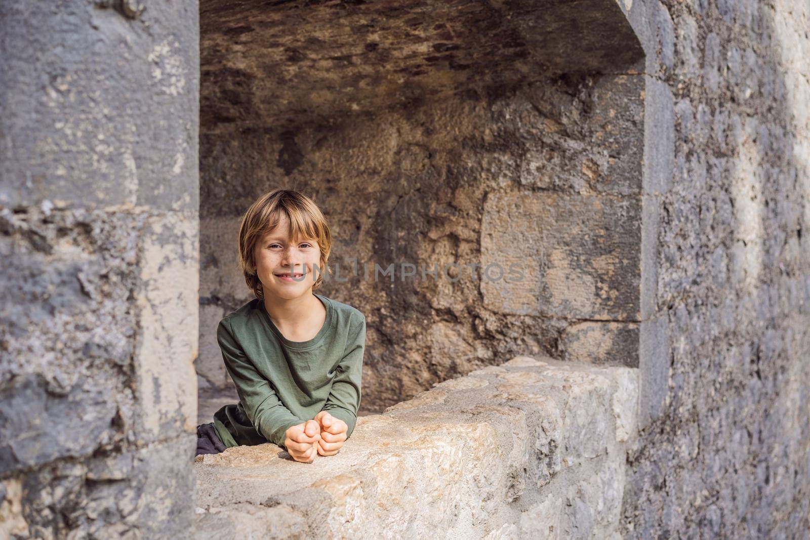 Boy tourist enjoying Colorful street in Old town of Kotor on a sunny day, Montenegro. Travel to Montenegro concept by galitskaya