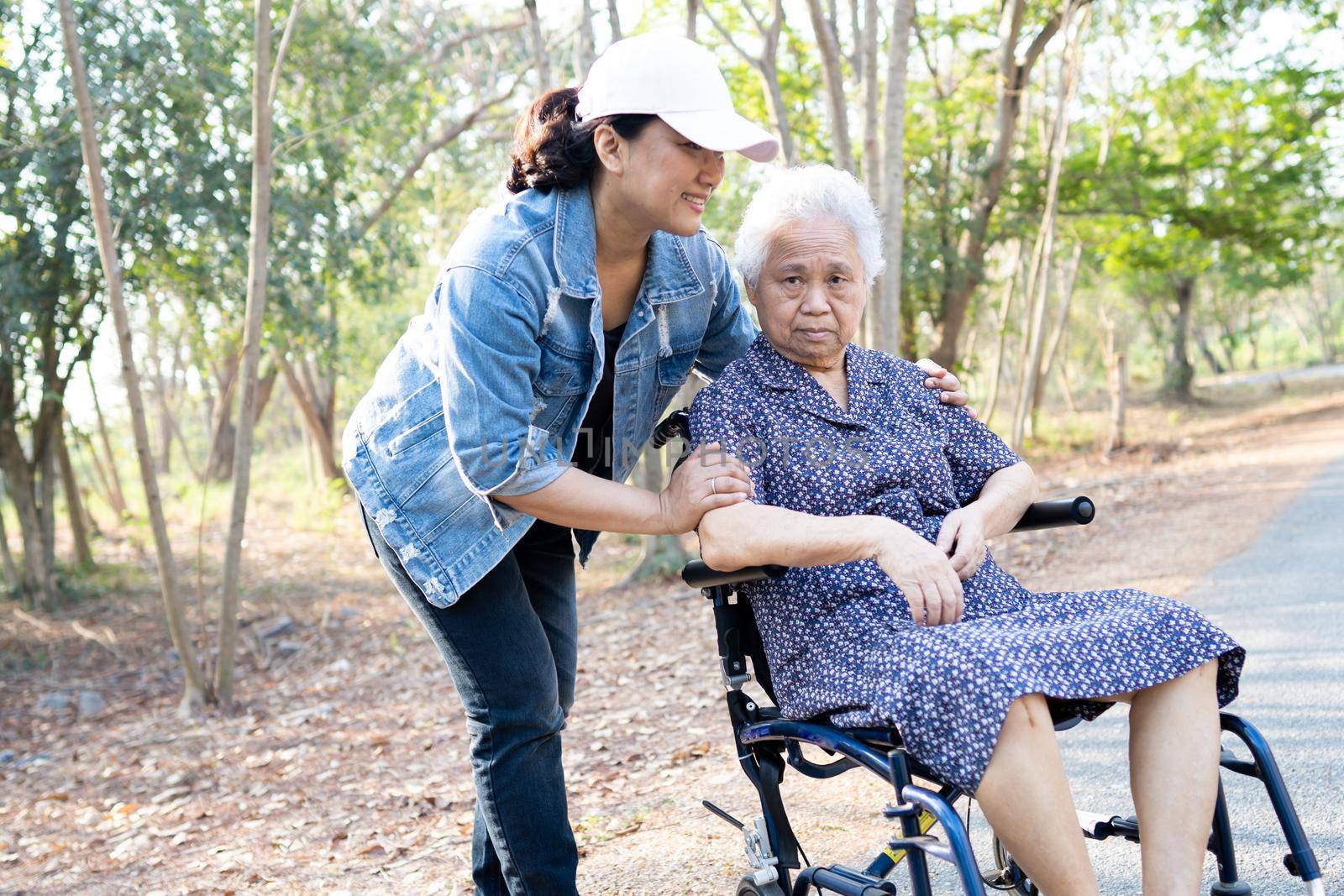 Asian senior or elderly old lady woman patient on wheelchair in park, healthy strong medical concept