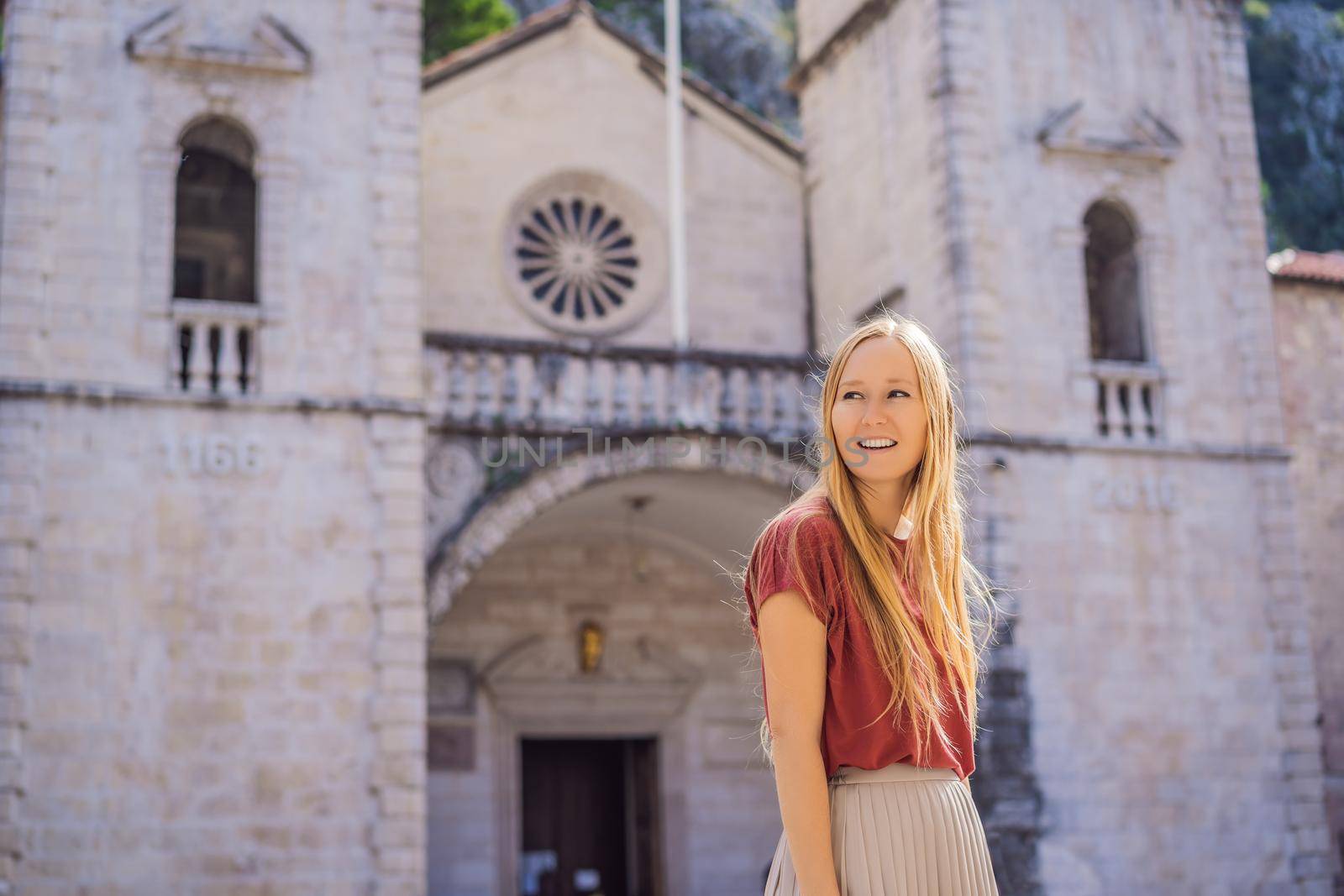 Woman tourist enjoying Colorful street in Old town of Kotor on a sunny day, Montenegro. Travel to Montenegro concept by galitskaya