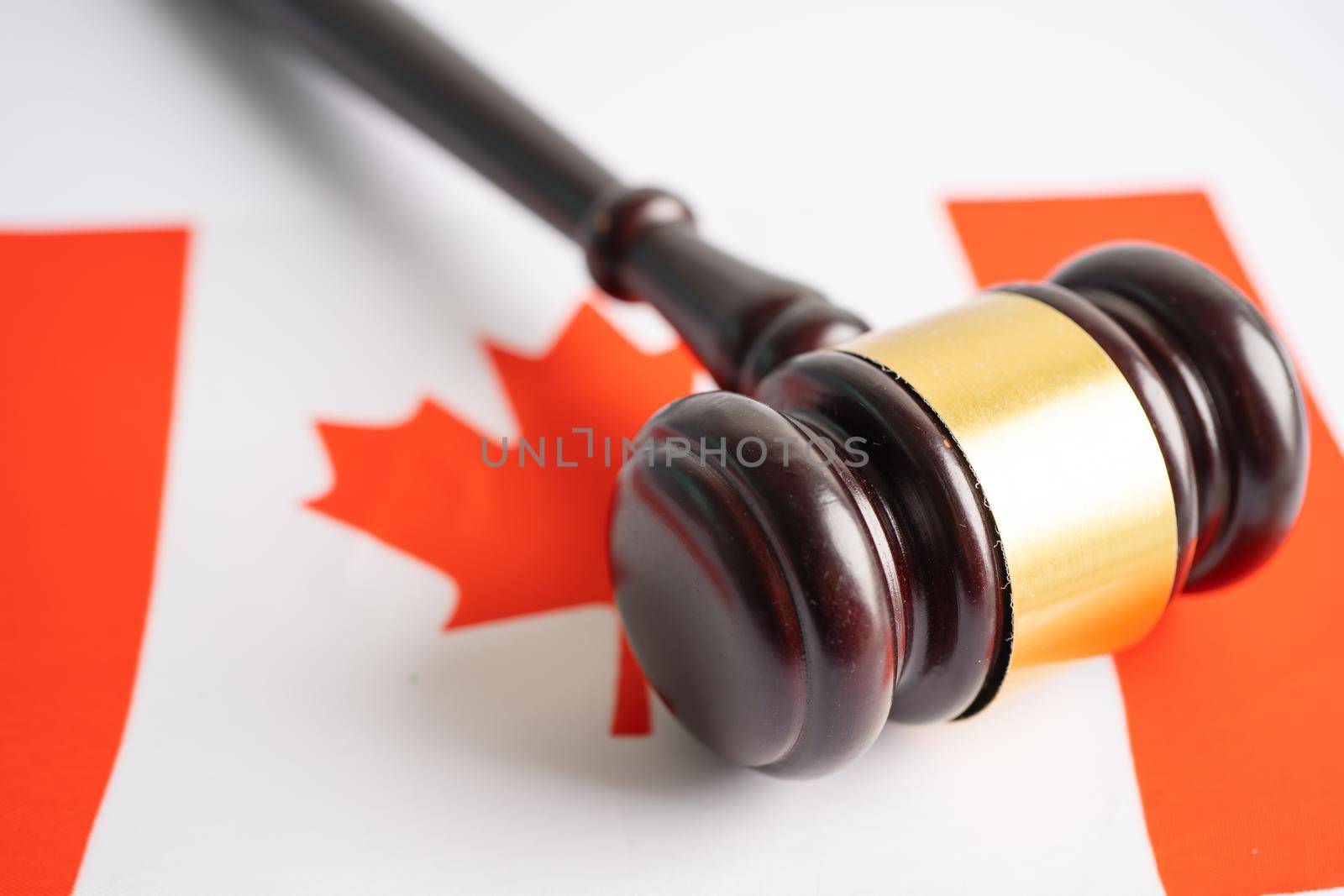 Canada flag with gavel for judge lawyer. Law and justice court concept. by pamai