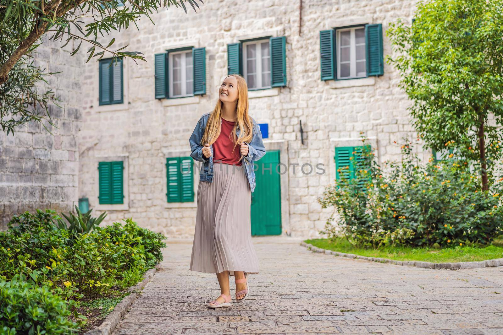 Woman tourist enjoying Colorful street in Old town of Kotor on a sunny day, Montenegro. Travel to Montenegro concept by galitskaya