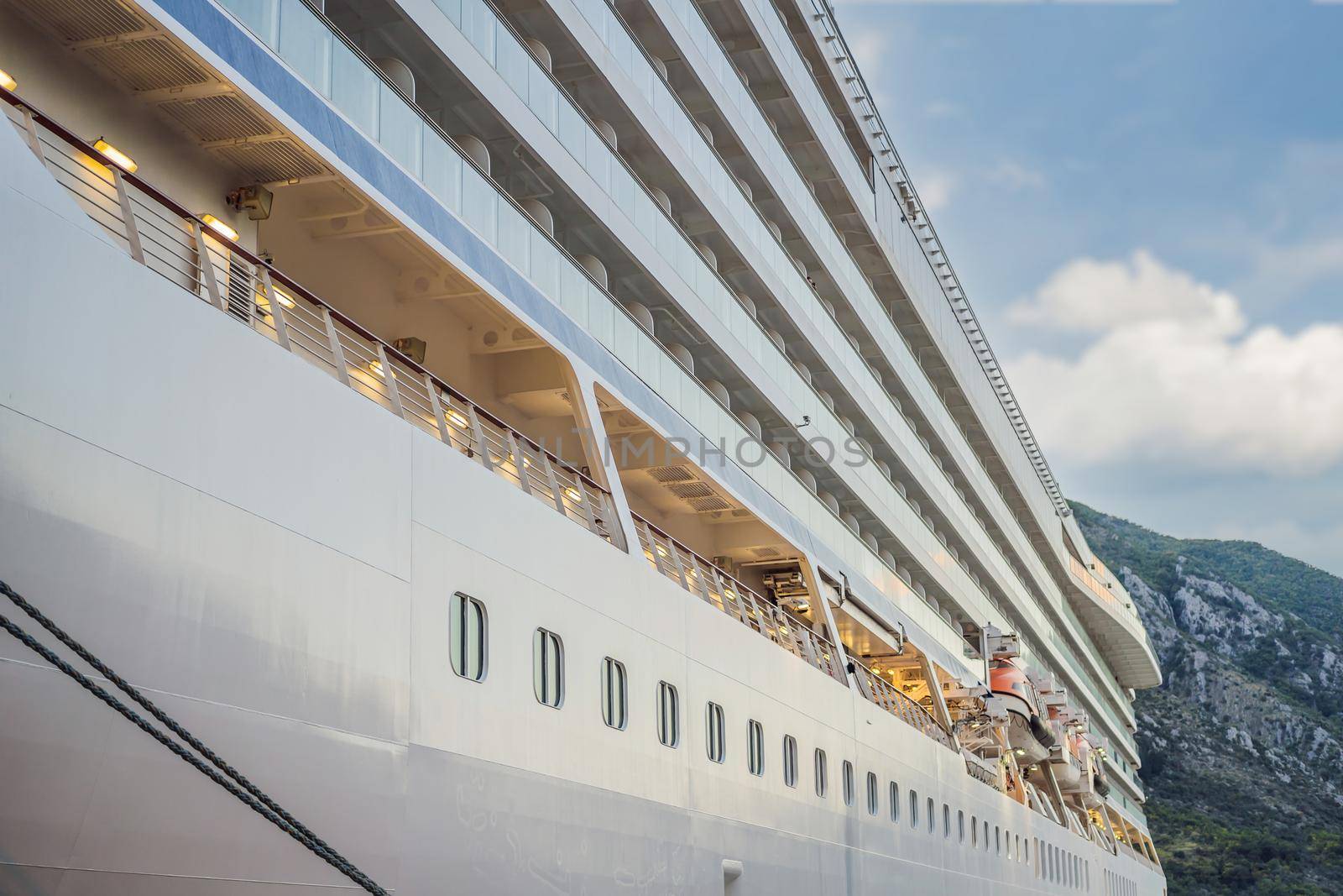 Cruise ship at harbor. Beautiful large white ship at sunset. Colorful landscape with boats in marina bay, sea. Luxury cruise. Floating liner.