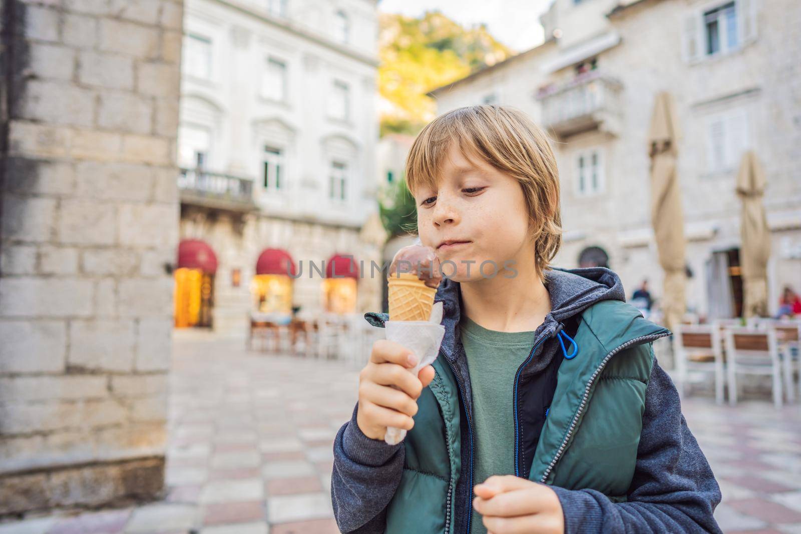 Boy tourist enjoying Colorful street in Old town of Kotor on a sunny day, Montenegro. Travel to Montenegro concept.