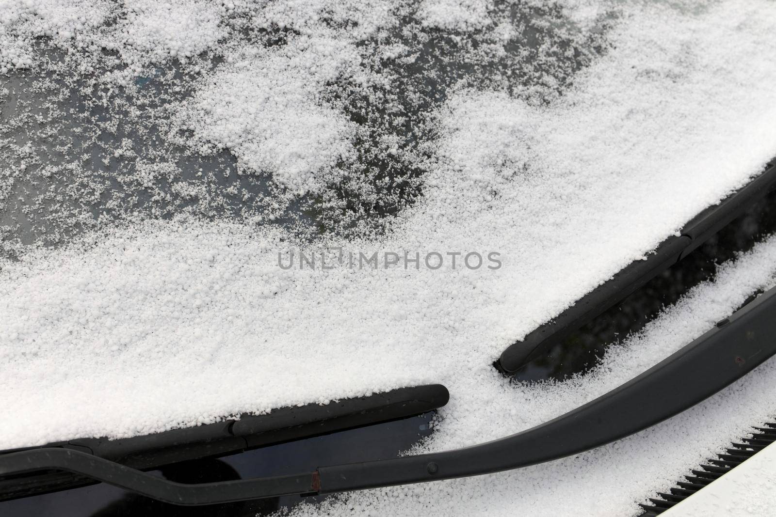 Close up of Graupel Snow pellets on a Windshield of a Vehicle by markvandam