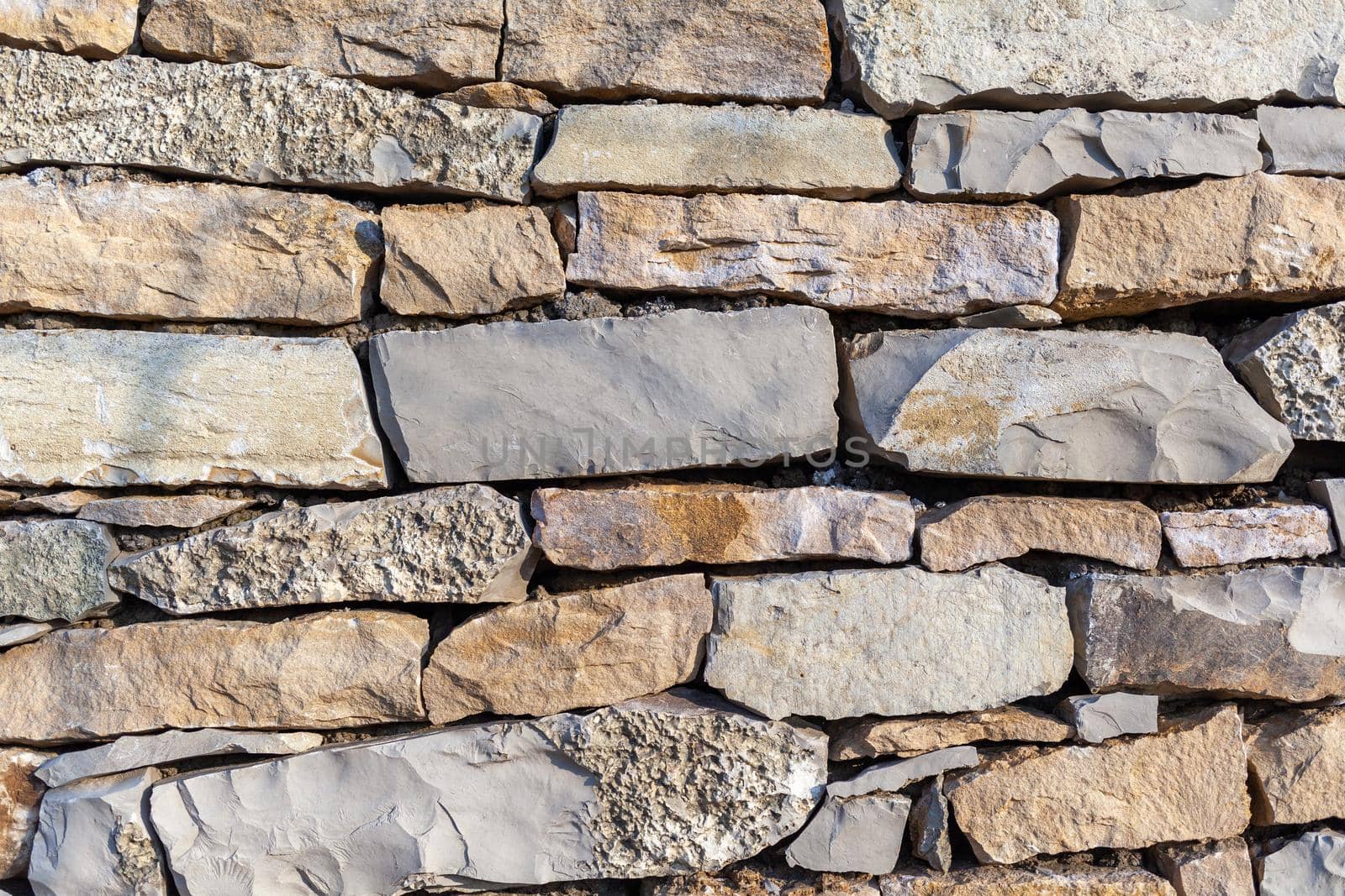 Texture of a stone wall. Old castle stone wall texture background.  by AnatoliiFoto