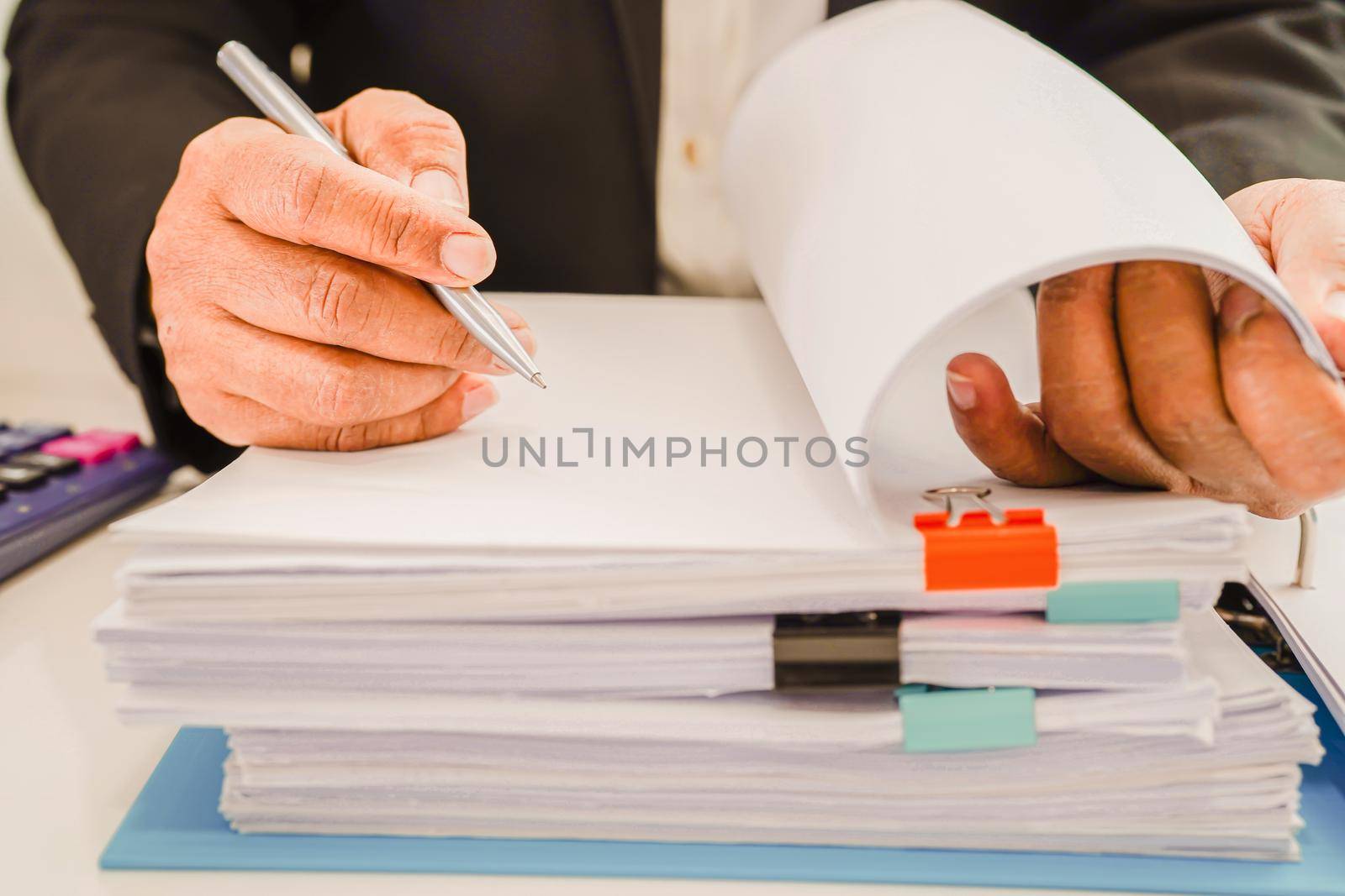 Businessman working and prepare paperwork report data to analysis information in file binder at office.