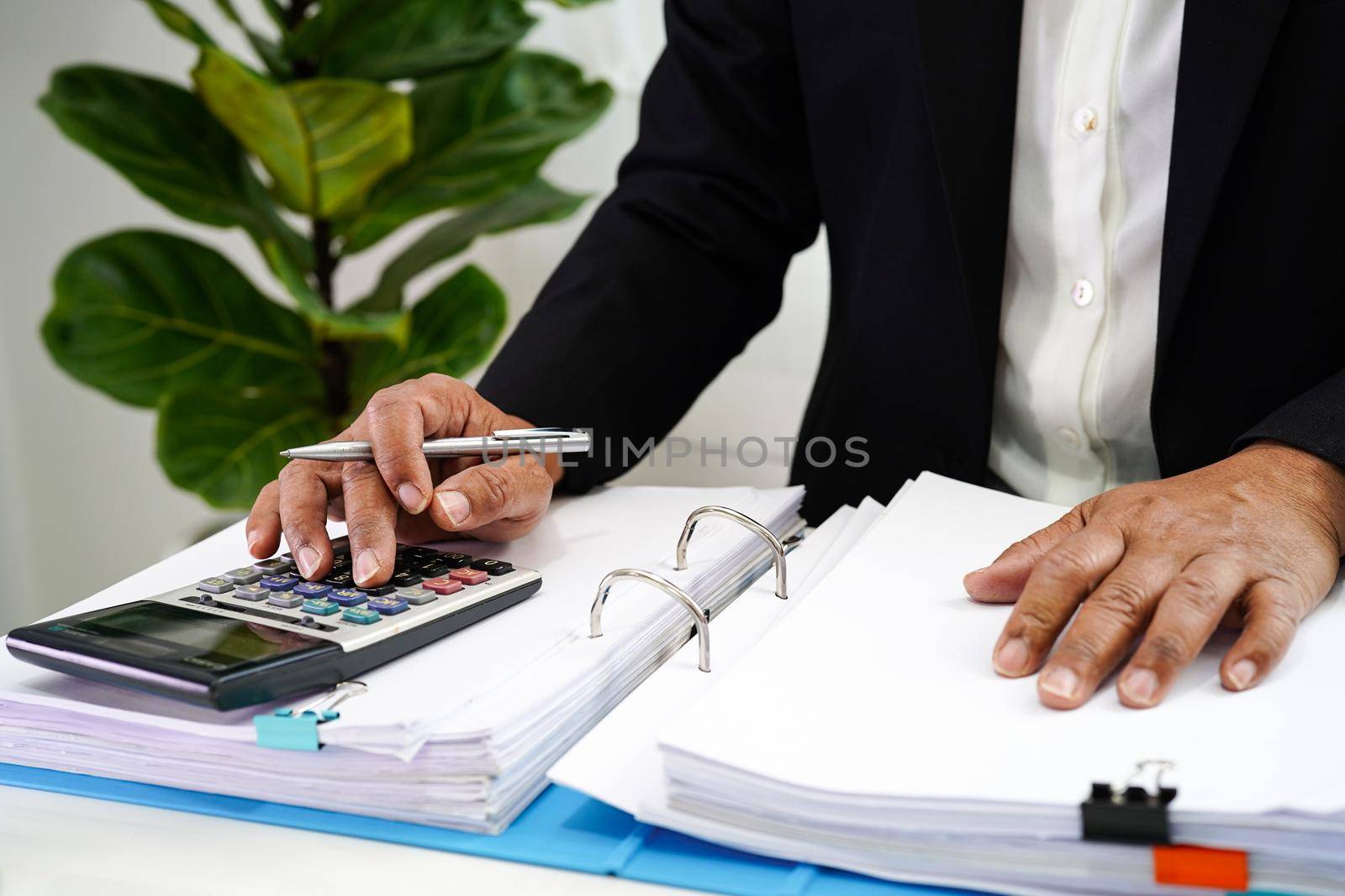 Businessman working and prepare paperwork report data to analysis information in file binder at office.    
