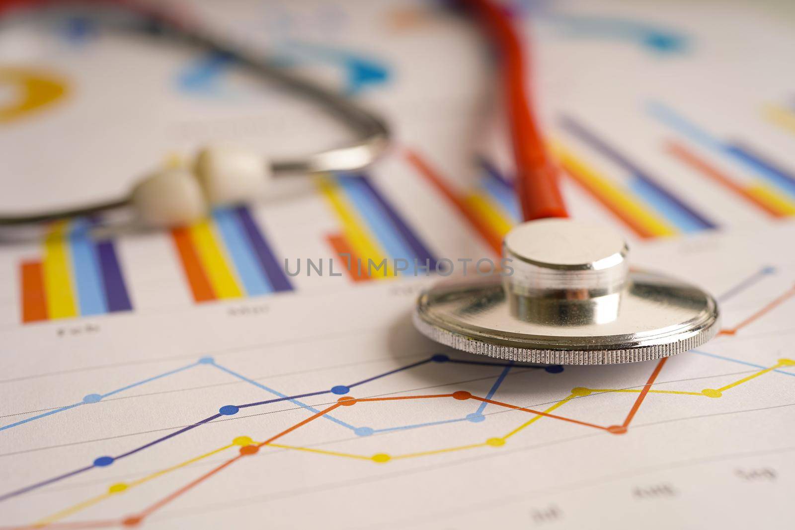 Stethoscope on charts and graphs spreadsheet paper, Finance, Account, Statistics, Investment, Analytic research data economy and Business company concept.           