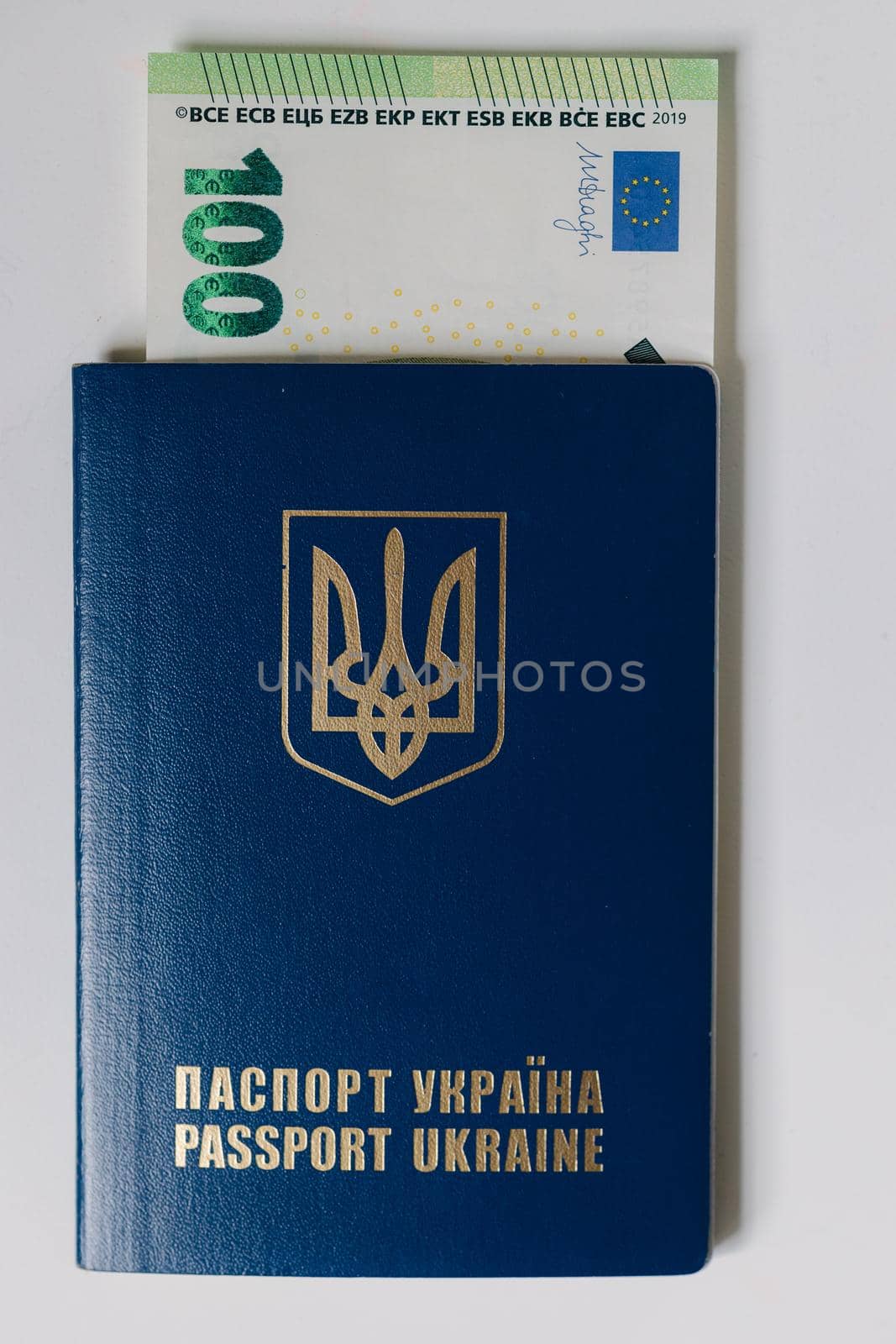 Hundred euro banknote inside Ukrainian passport. Bribe during the war.