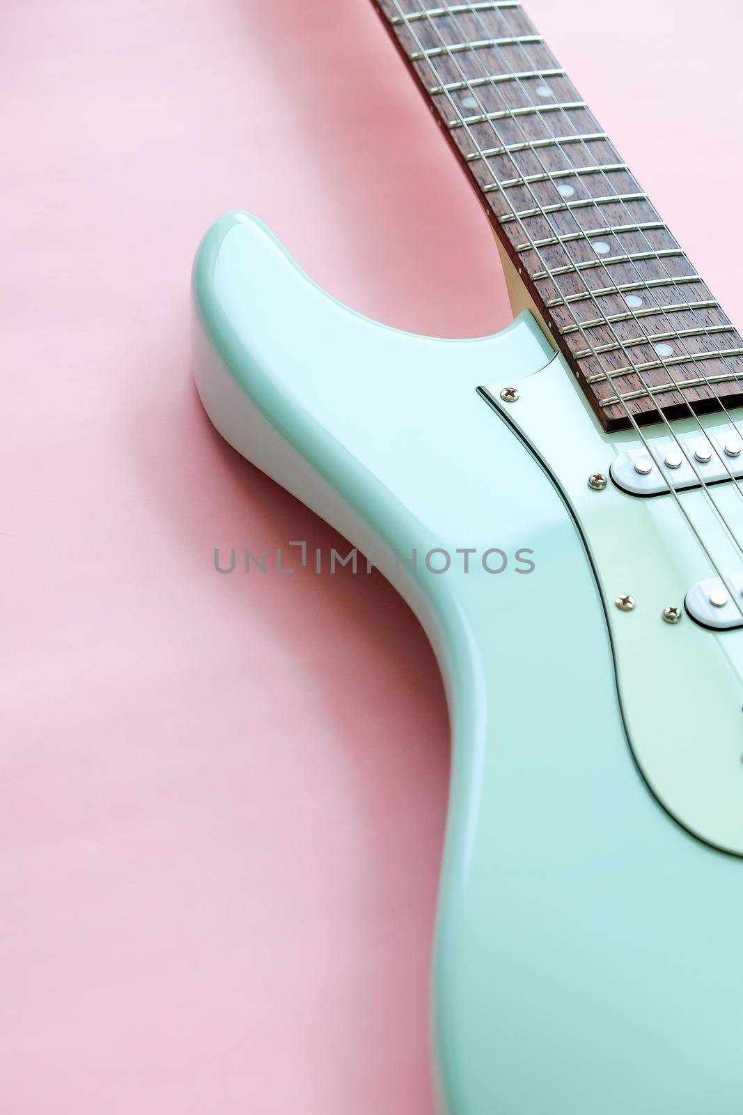 Mint Green Electric Guitar on a Pink by ponsulak