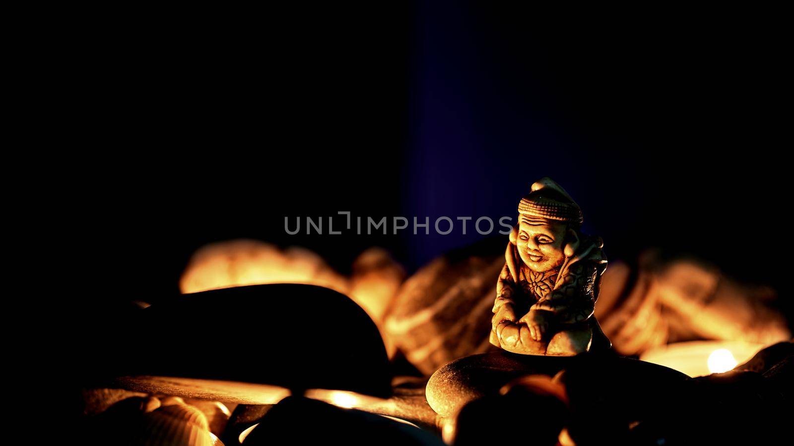 Buddhist wise holy monk warming himself by the fire on a dark night by jovani68