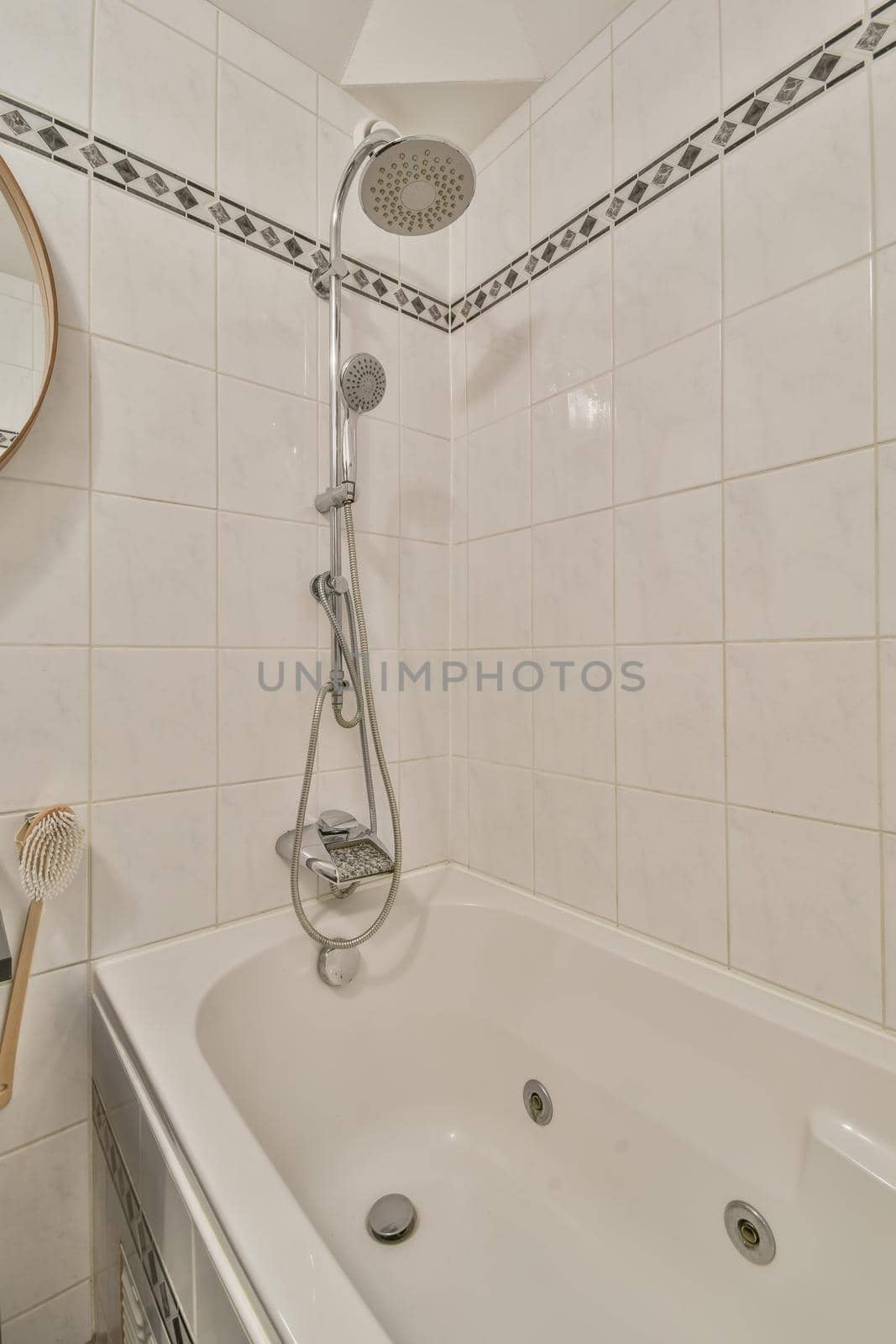 Bathroom interior with white tiles and a pattern on it, as well as with a bathtub and shower