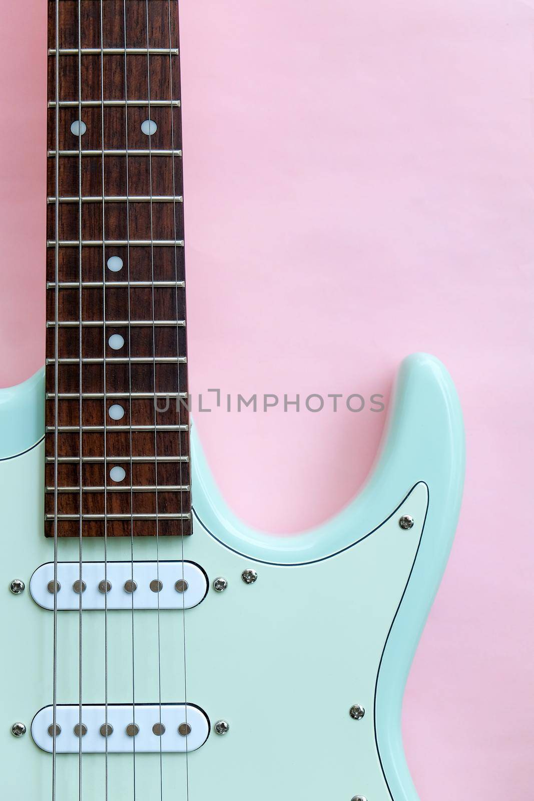 Mint Green Electric Guitar on a Pink by ponsulak