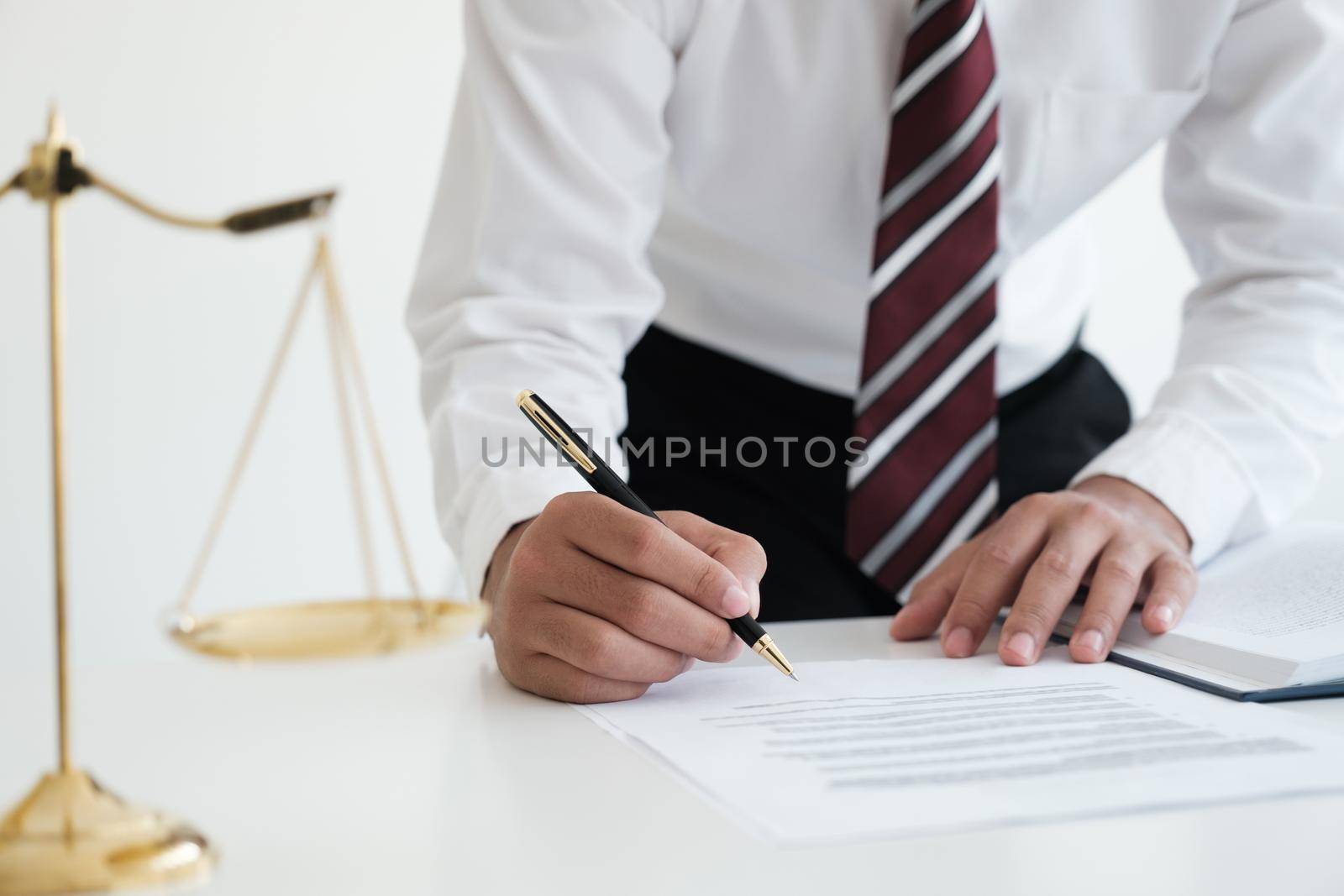 Lawyer Signing Documents Near Mallet And Scales. by ijeab