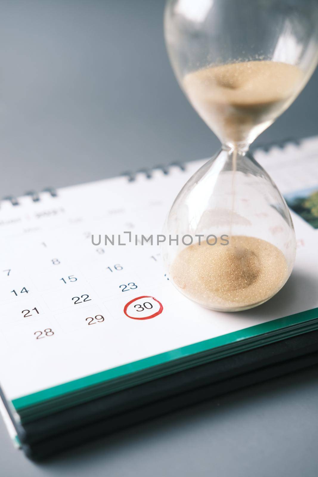 hourglass on table, Sand flowing through the bulb of Sandglass.